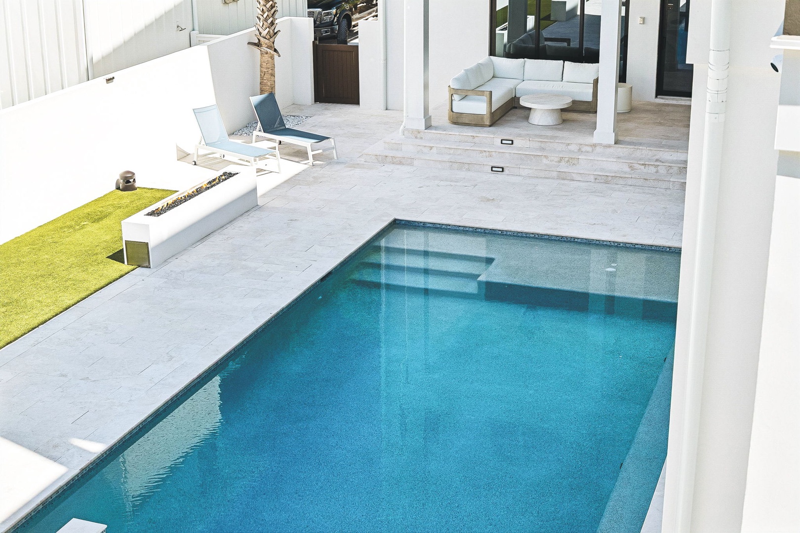 Imagine lounging by your private pool, soaking up the sun on sleek chaise chairs. The covered patio invites you to relax with a cool drink, while the open layout flows effortlessly between indoor comfort and outdoor bliss.