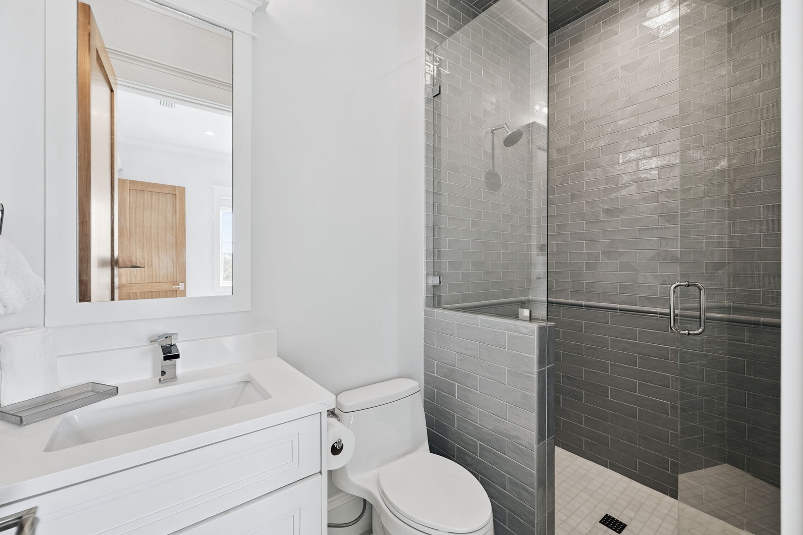 Refresh in your private spa-like bathroom featuring a sleek glass shower with gorgeous subway tiles and modern vanity.