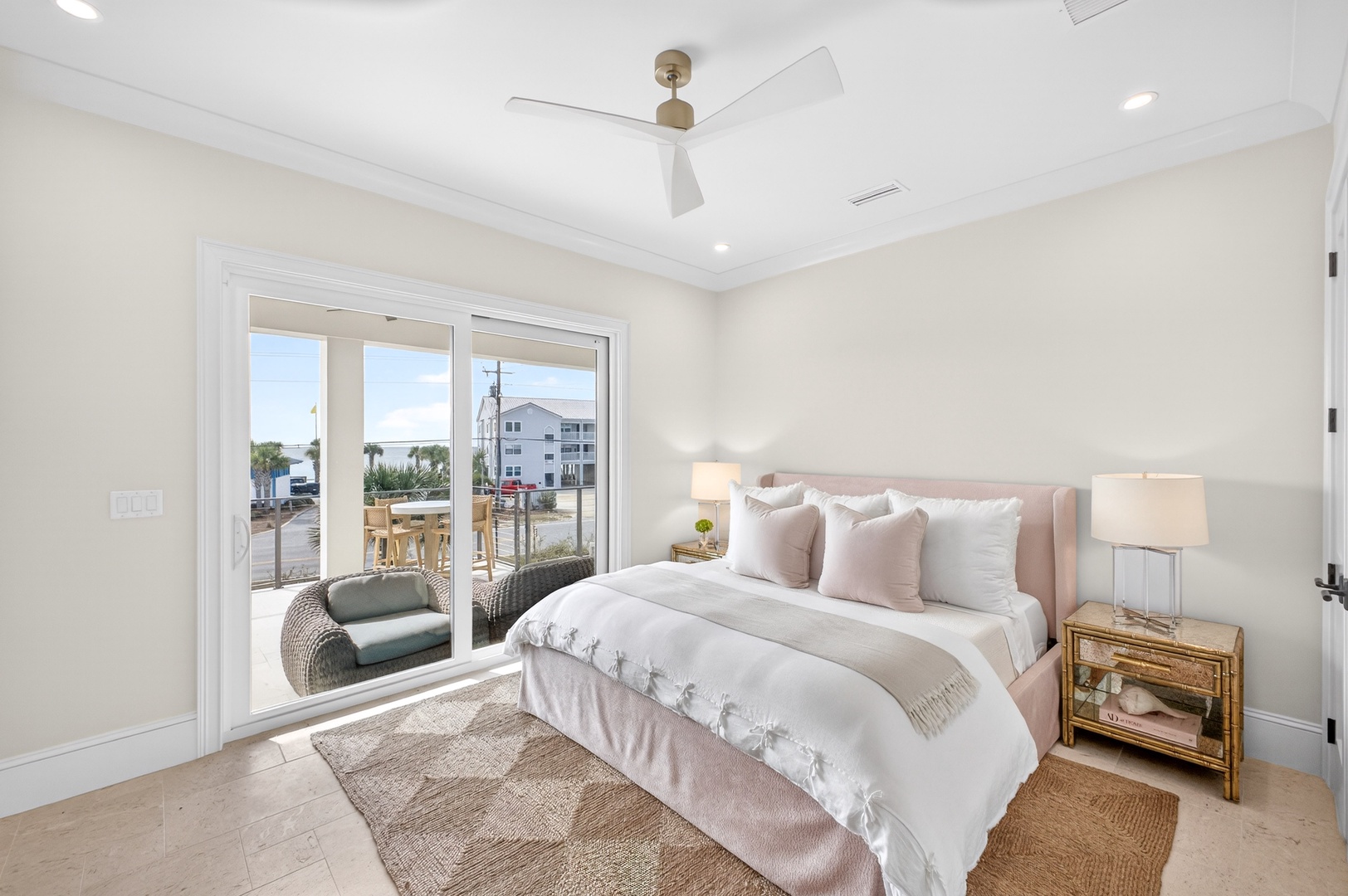 Your serene bedroom features elegant coastal decor and French doors opening to a private balcony, perfect for morning coffee or evening relaxation.