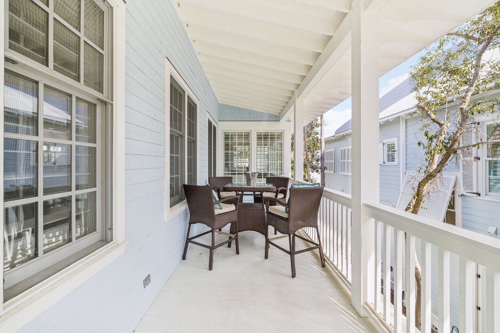 Step onto your private covered porch with wicker seating for peaceful morning coffee or evening relaxation.