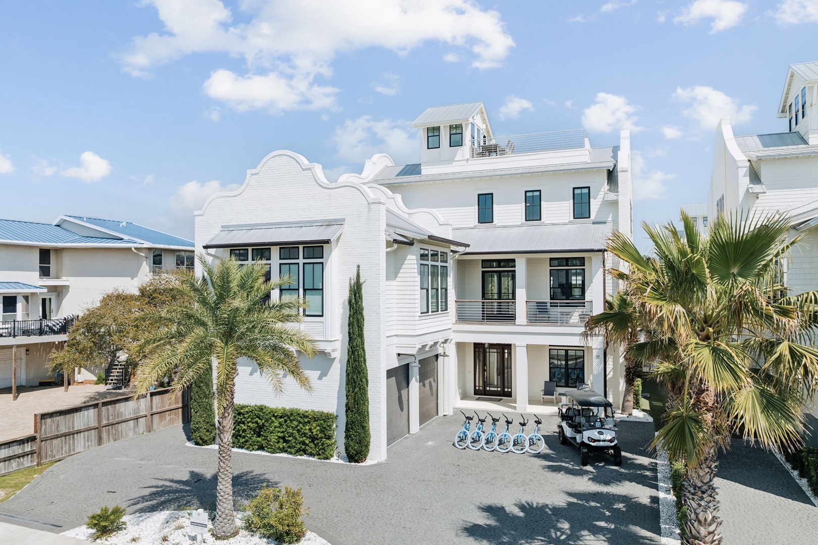 Modern coastal architecture with palm trees and tropical landscaping creates an inviting beachside retreat.