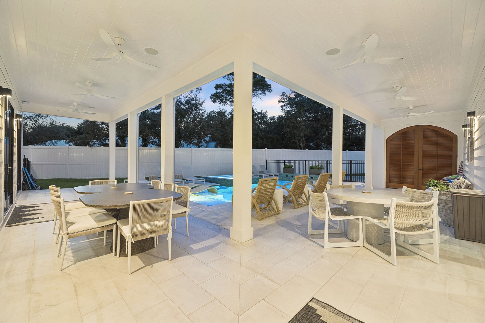 Gather around the table for meals or games while the pool beckons just beyond your covered patio, blending indoor comfort with outdoor fun.