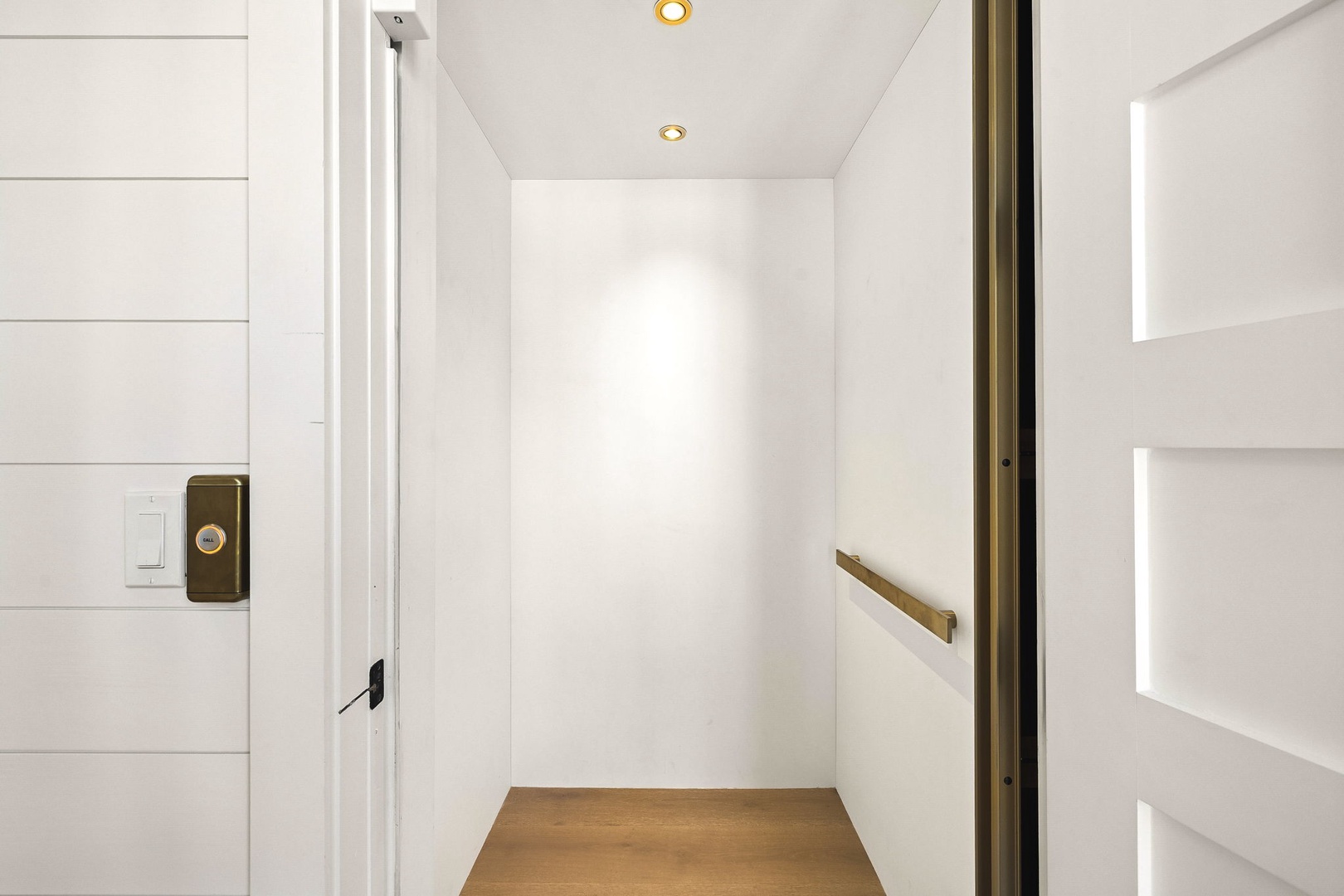 Walk into your private, modern hallway where clean lines and warm lighting create a welcoming first impression.