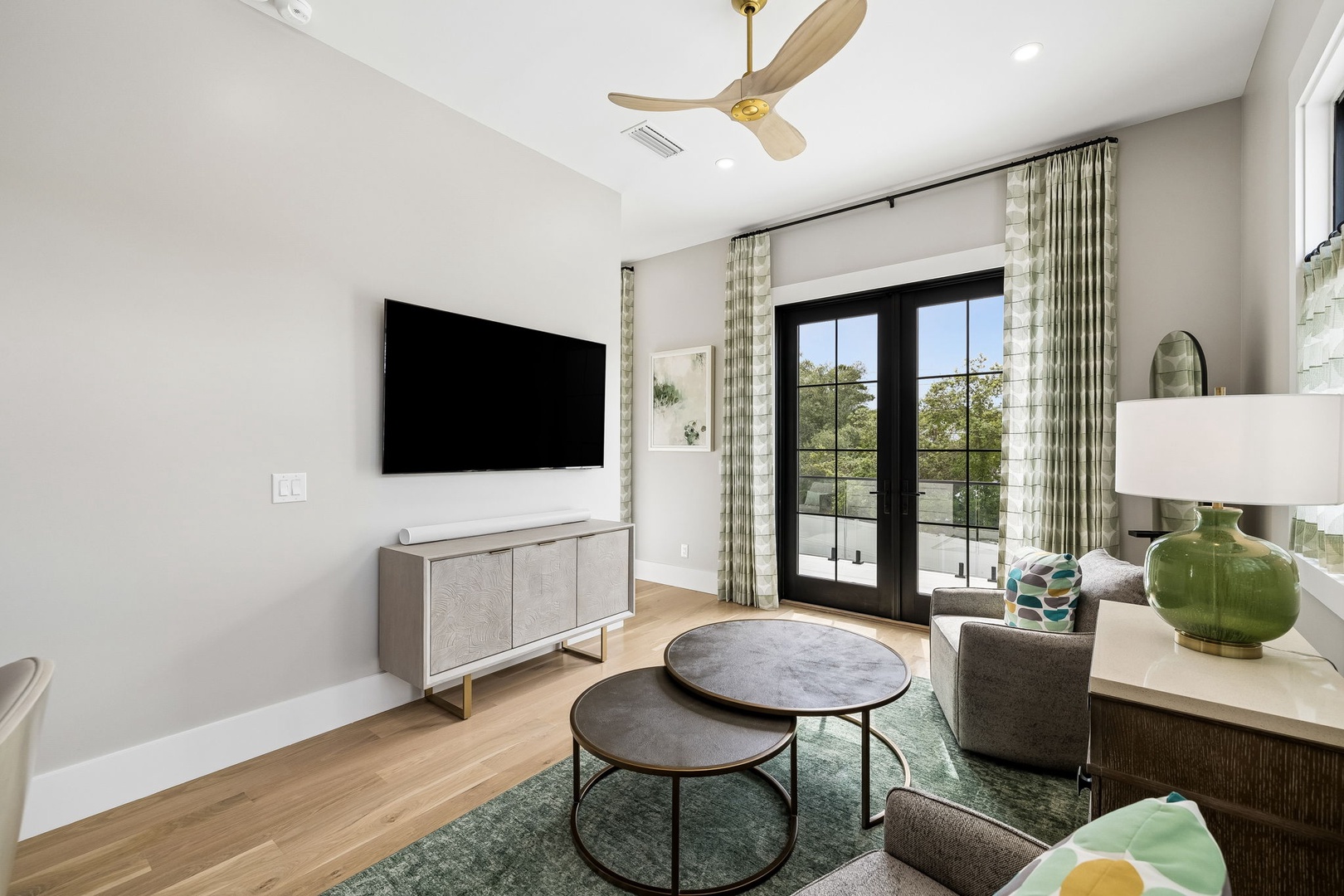 Unwind in your bright living space with modern comforts, stylish furnishings, and French doors opening to a peaceful outdoor retreat.