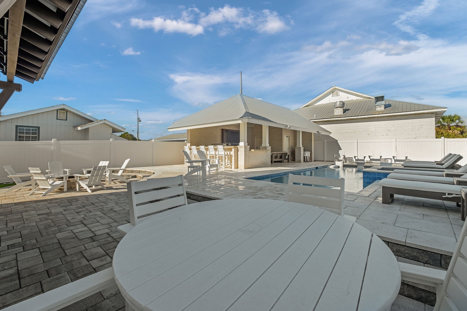Spacious pool deck with outdoor dining and lounge seating where you can soak up the Florida sunshine.