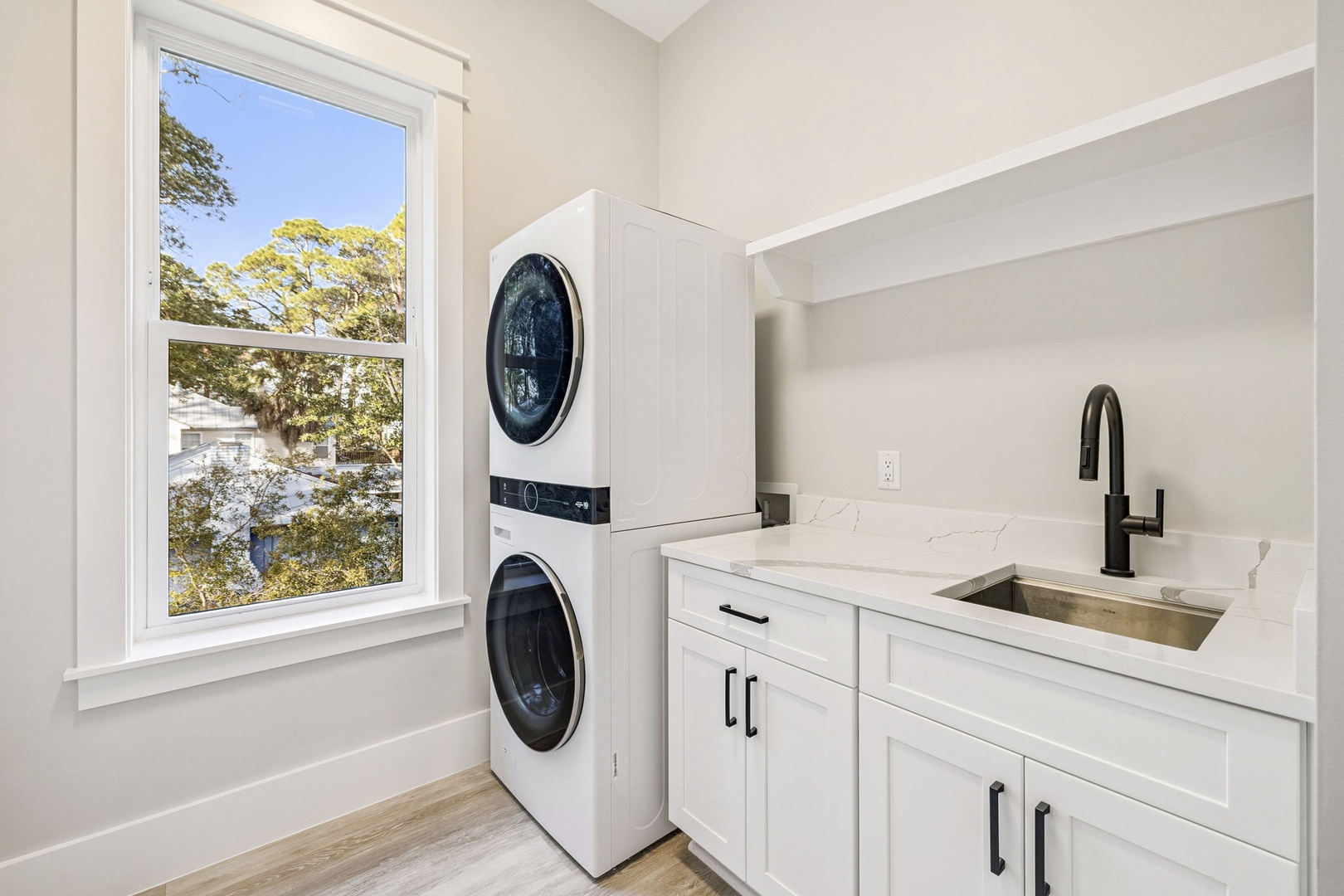 Your dedicated laundry room features modern appliances and elegant marble countertops, making household tasks feel effortless during your stay.