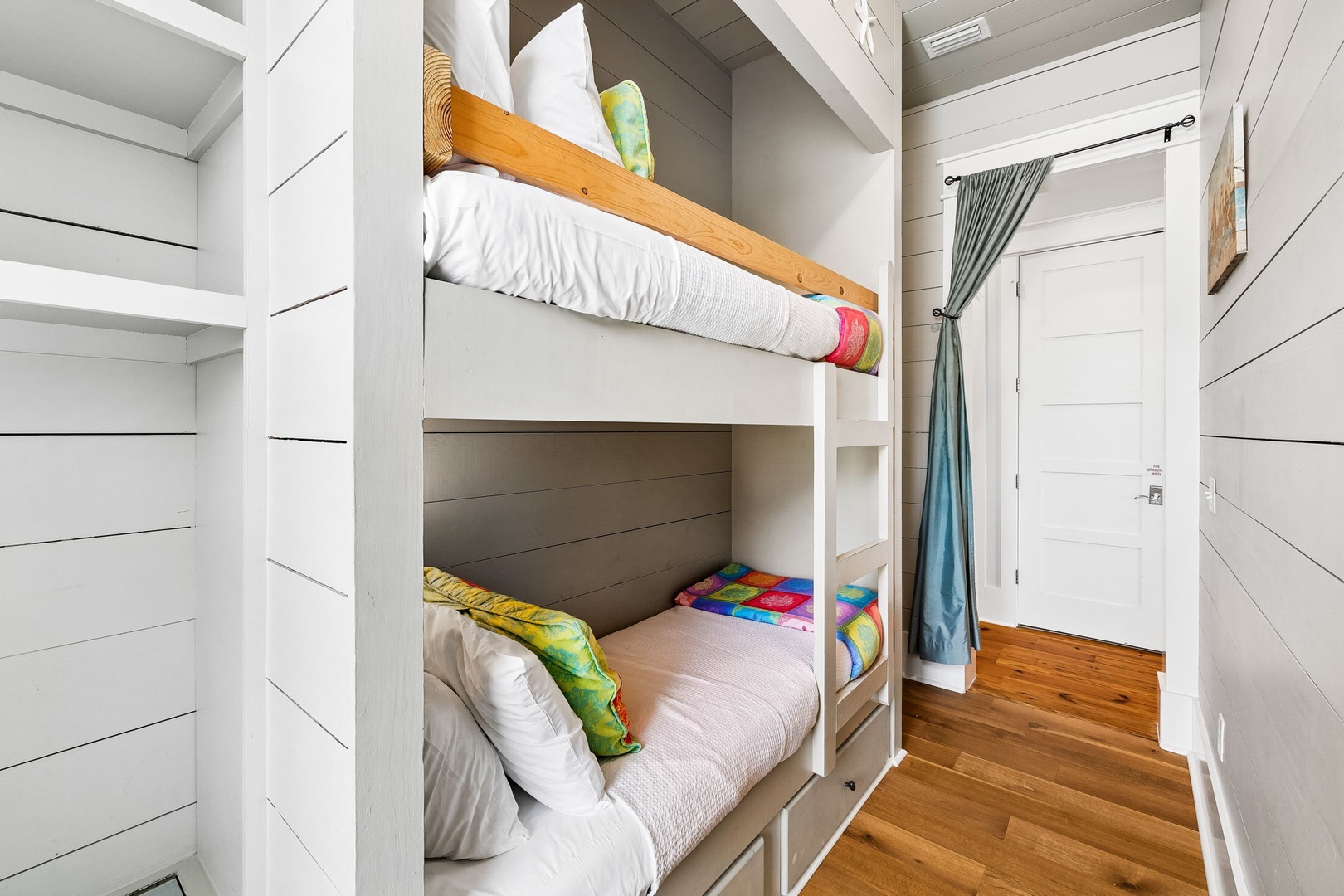 Rest easy in your cozy bunk room, where custom-built beds with crisp linens and colorful pillows promise comfort for the whole crew after a day of adventure.