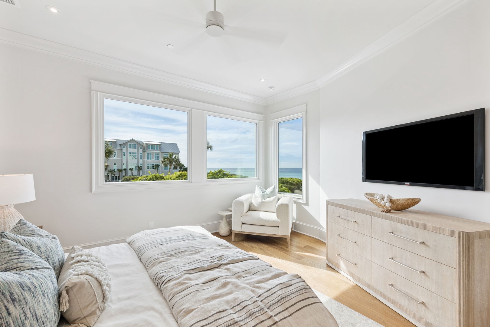 Wake up to bright ocean views framed by soft coastal light. Your serene bedroom features plush bedding, a cozy reading nook, and entertainment center—your tranquil retreat by the sea.