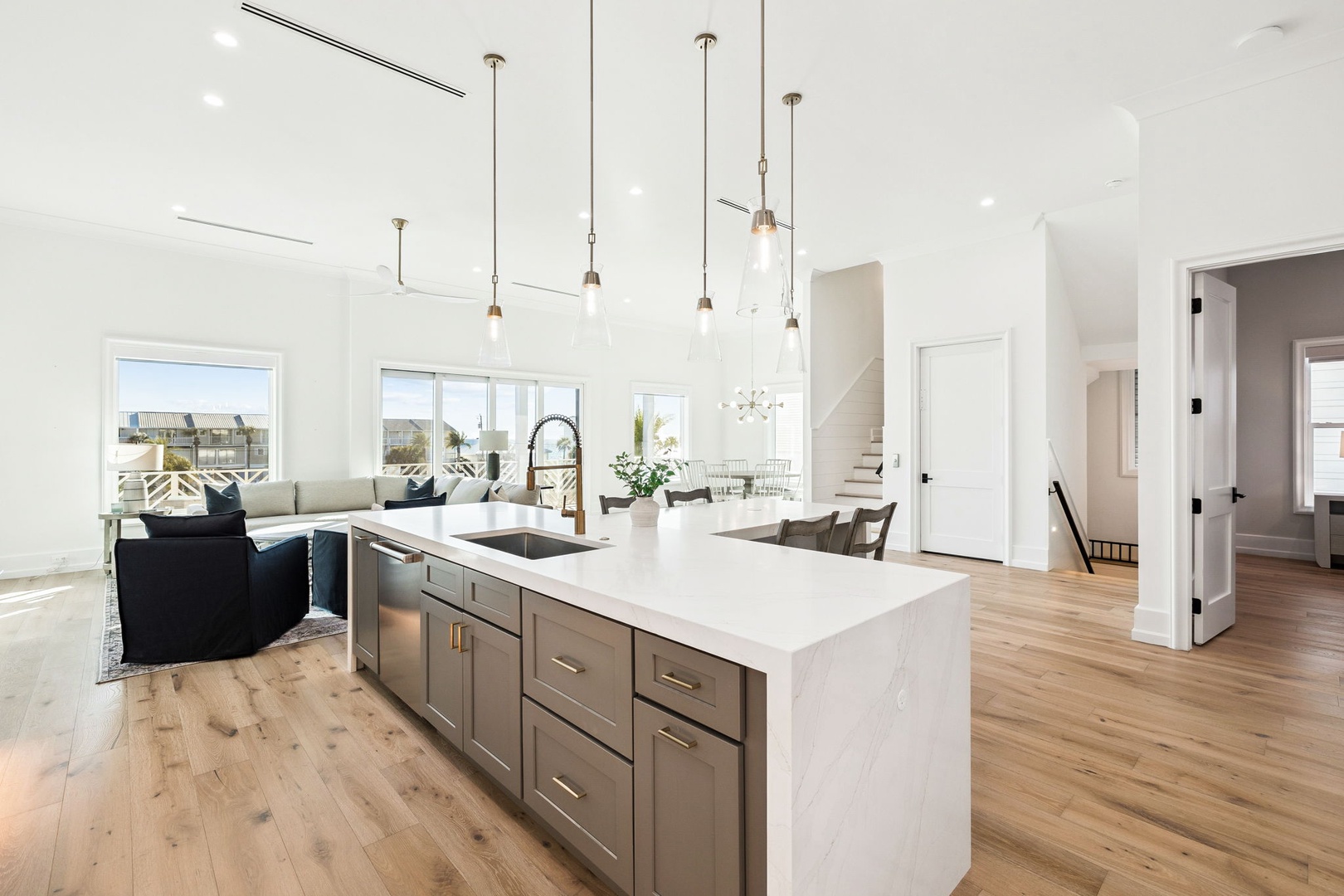 Your stunning open-concept kitchen flows seamlessly into the living space, featuring marble countertops and pendant lighting for memorable cooking experiences.