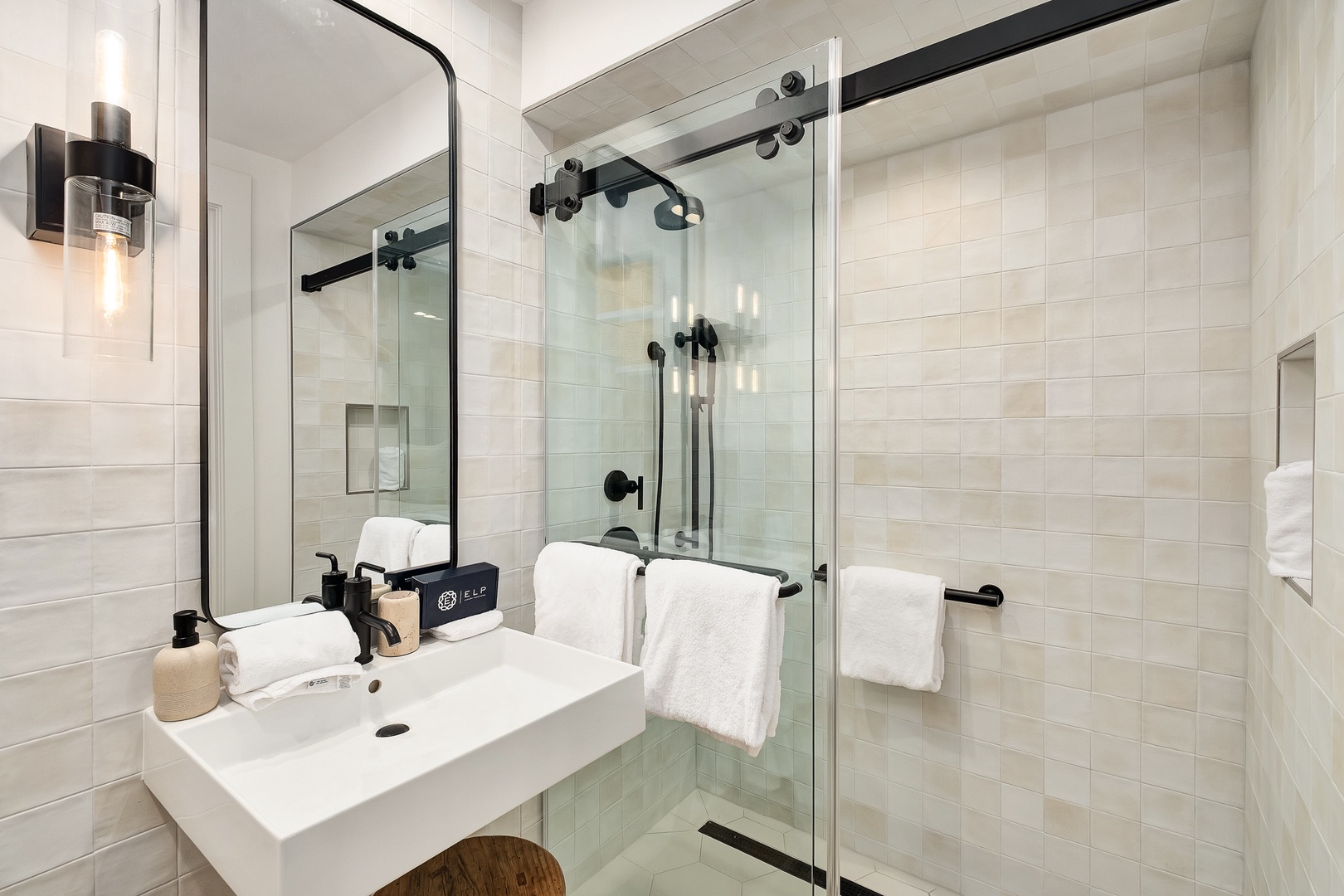 Your modern bathroom features a spacious walk-in shower with sleek glass doors and premium fixtures for your comfort.
