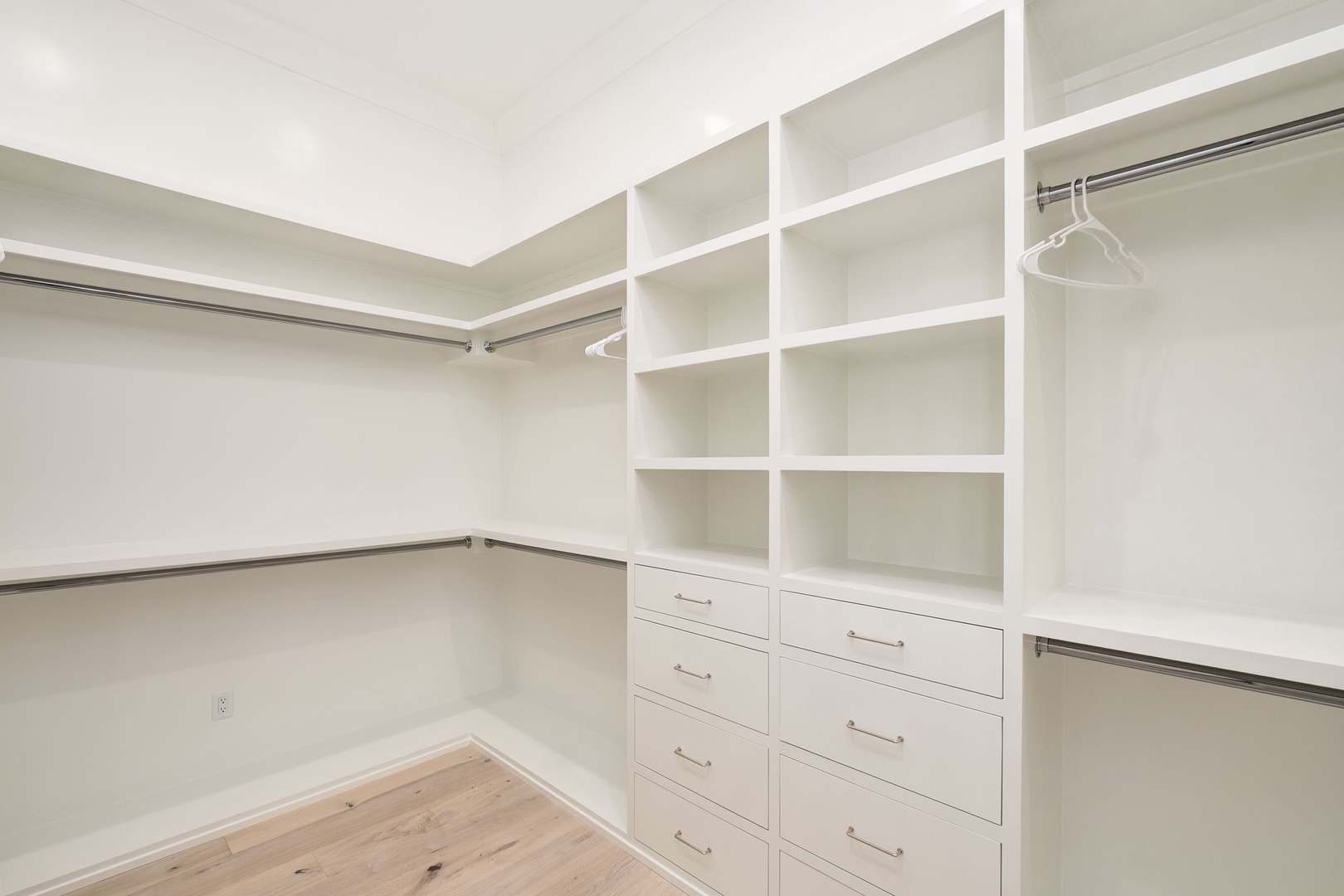 Your spacious walk-in closet features custom shelving, drawers, and hanging rods to keep your belongings perfectly organized during your stay.