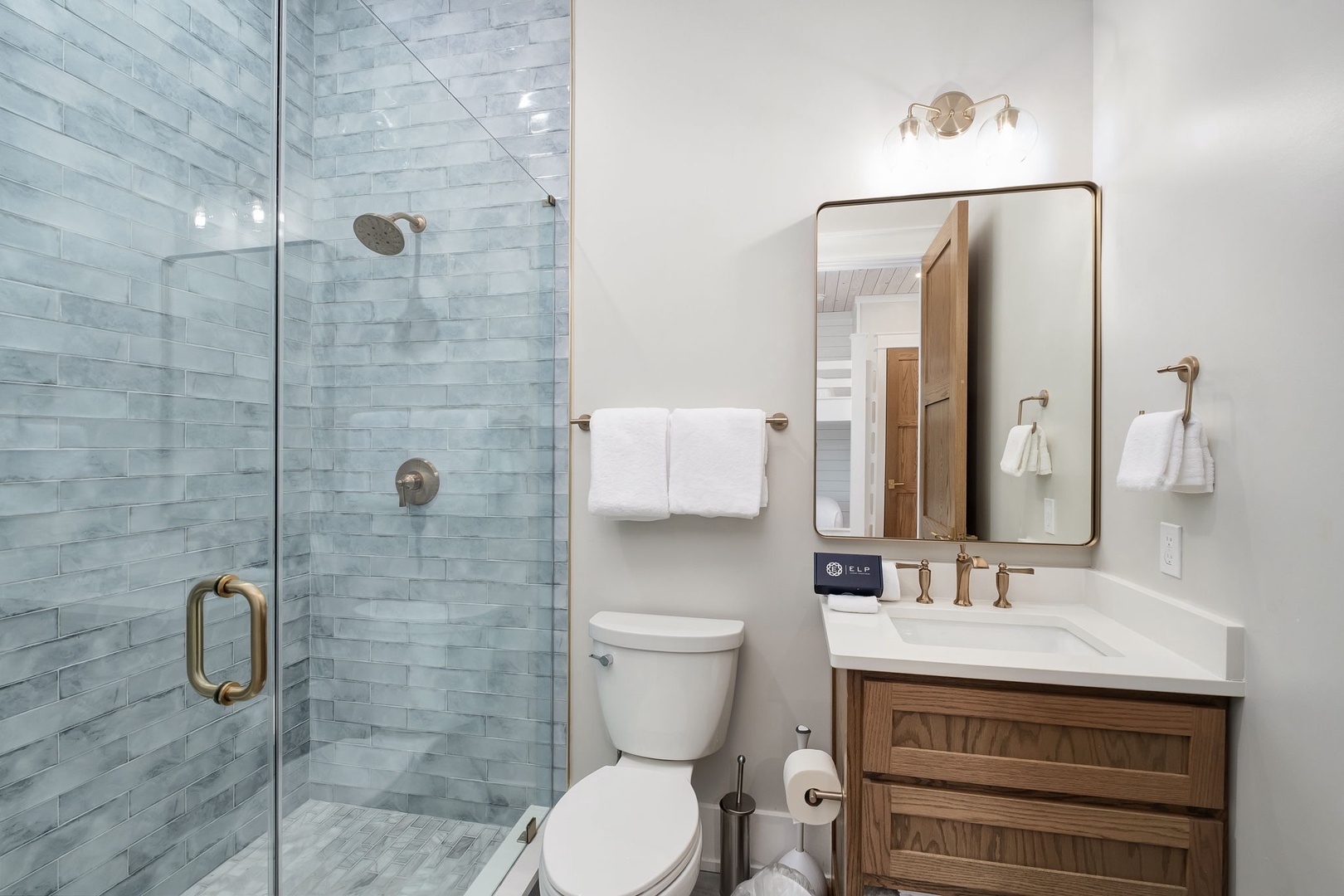 Step into your elegant bathroom featuring a spa-like tiled shower and beautifully appointed vanity for your daily refresh.