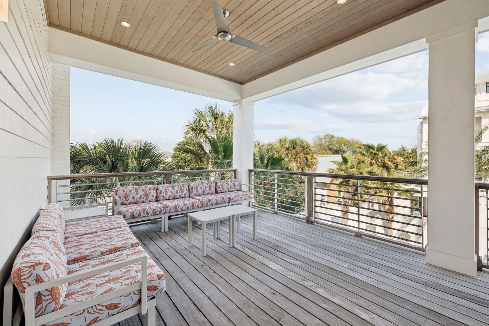 Your private covered balcony offers comfortable seating where you can unwind while enjoying tropical palm views and gentle breezes.