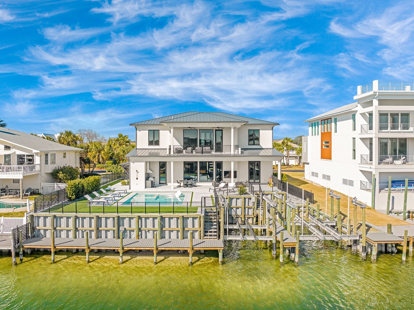 Stunning waterfront property featuring a private dock with direct water access and swimming pool.