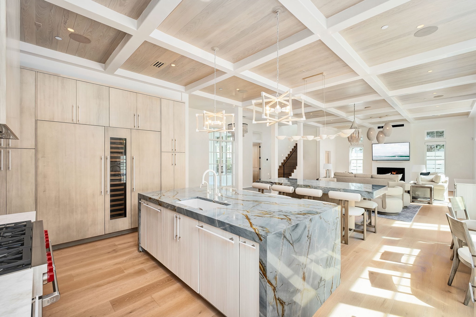 Stunning open living with soaring coffered ceilings and natural light. Your gourmet kitchen features premium appliances and a beautiful marble island, flowing seamlessly into the spacious lounge.