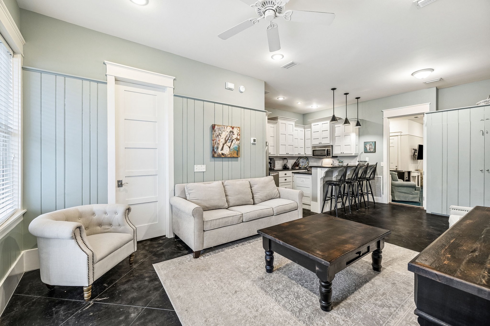 Relax in your inviting open-concept living area with plush seating and a fully equipped kitchen, perfect for gathering and making memories together.