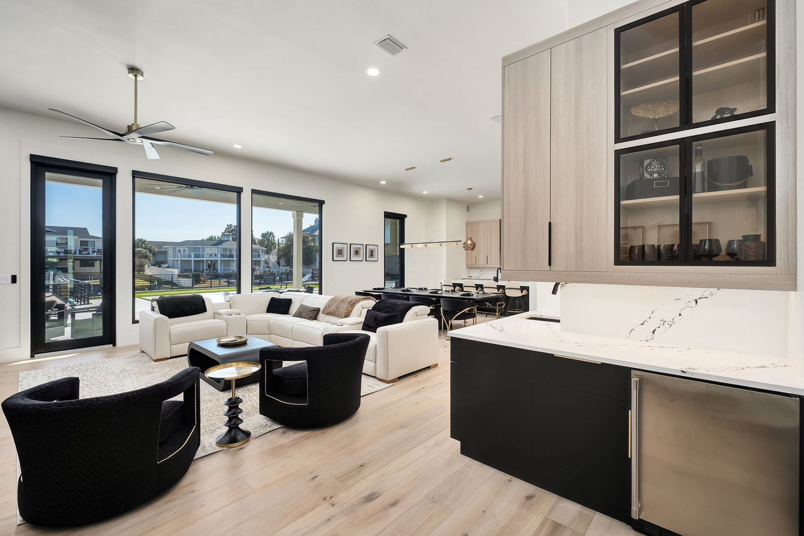 Your stunning open-plan living space blends modern luxury with comfort, featuring sleek marble countertops and panoramic views through floor-to-ceiling windows.