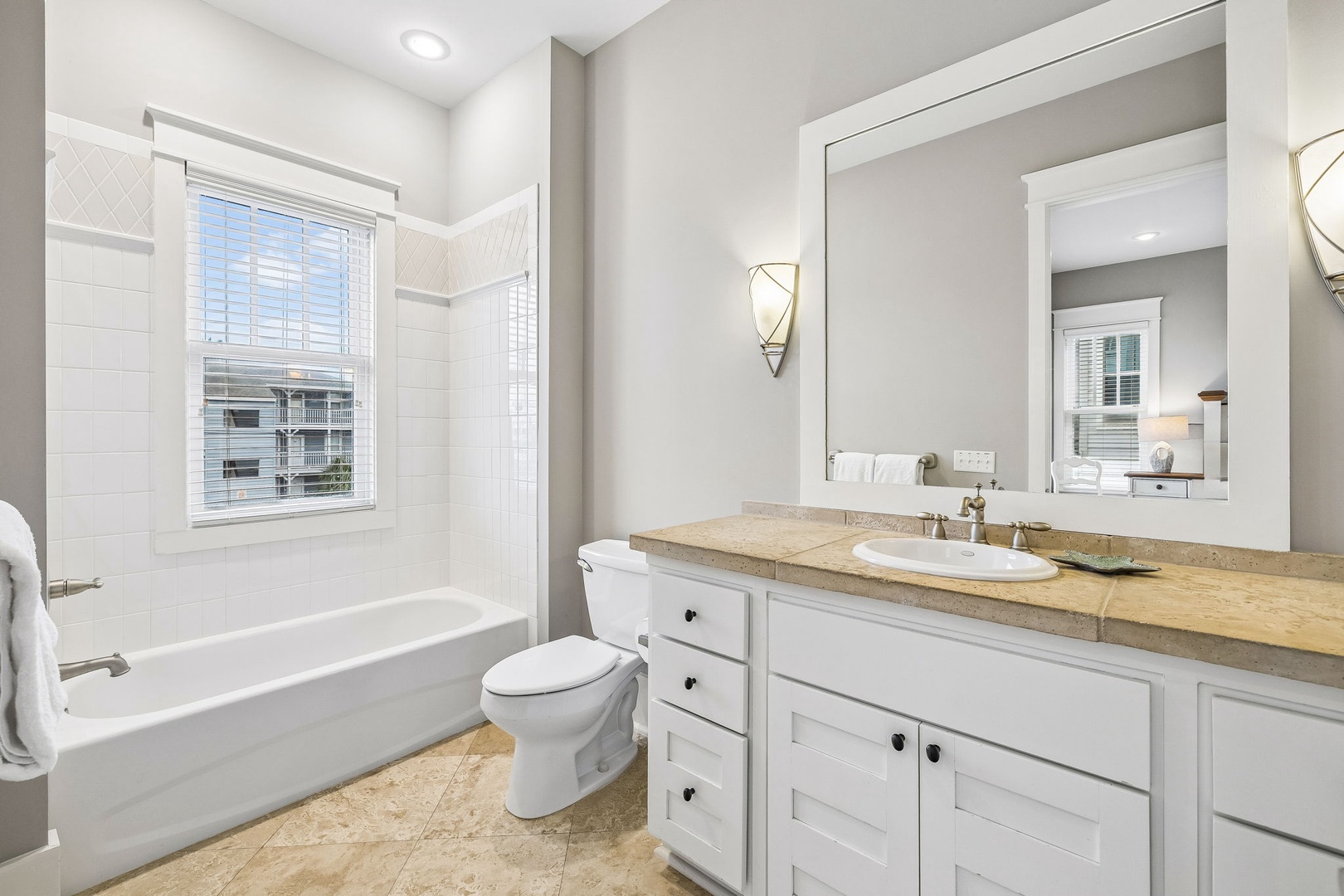 Freshen up in your serene bathroom with a soaking tub, elegant fixtures, and plenty of natural light streaming through the window.
