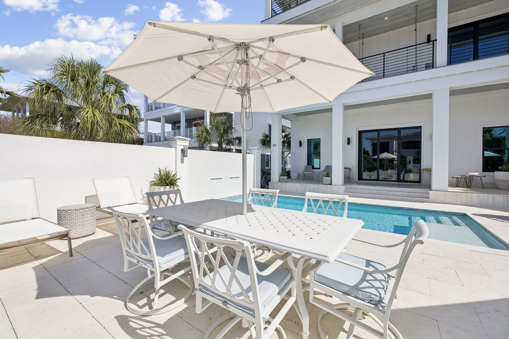 Soak up the sun at your private poolside dining table, where crystal-clear waters and tropical palms create your perfect outdoor sanctuary.