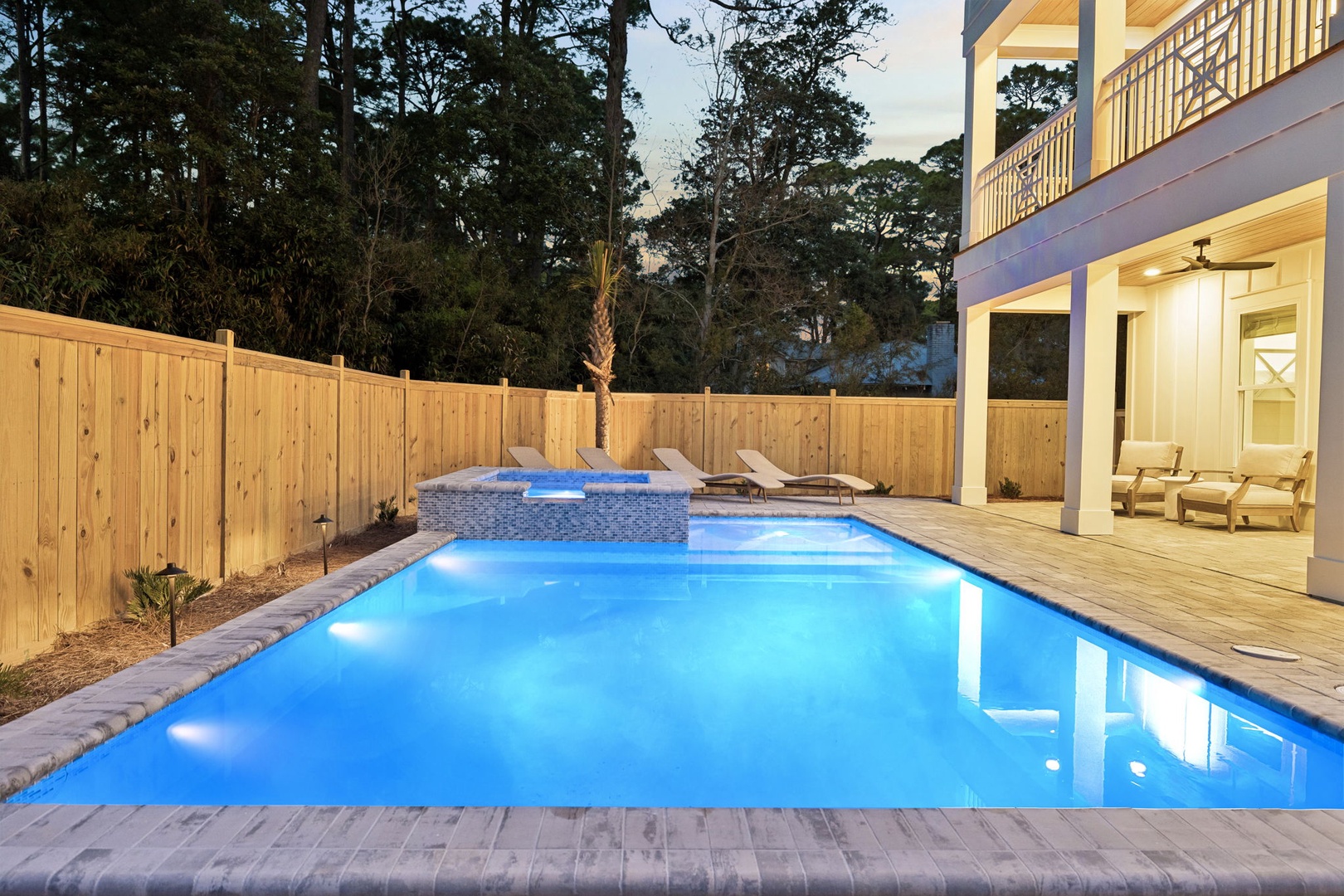 Dive into your private pool paradise, where crystal-clear waters and warm evening lights create the perfect backdrop for relaxation.