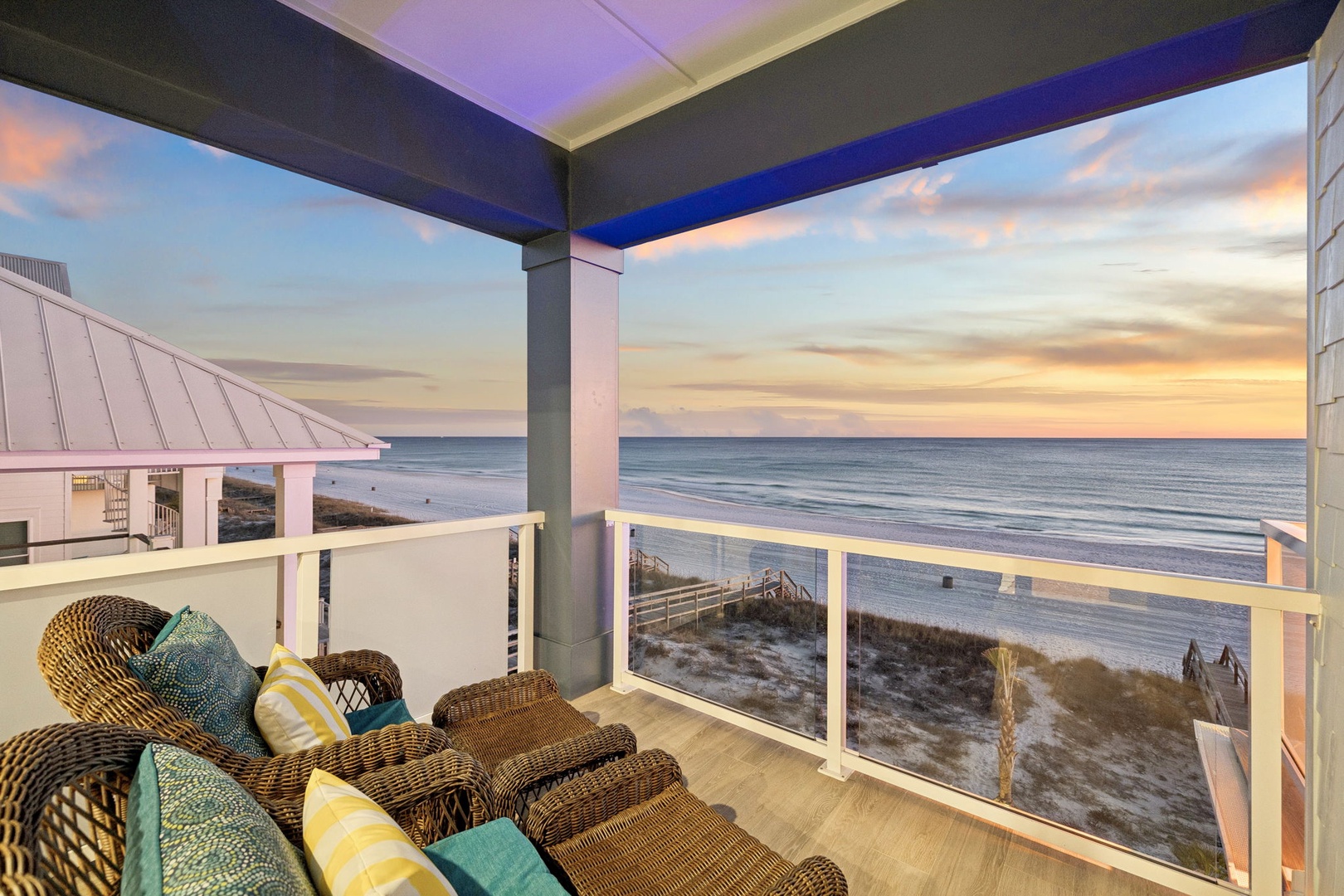 Unwind on your private balcony as the sun sets, watching waves roll onto pristine sand from your wicker seating.
