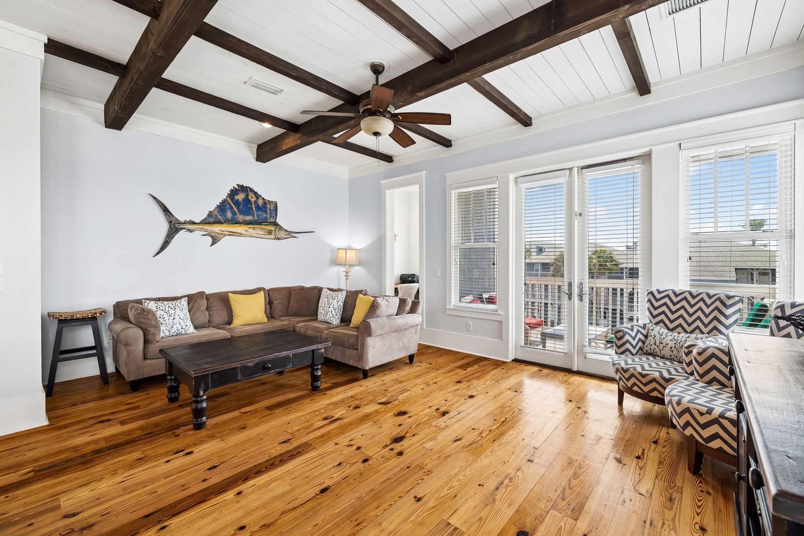 Stretch out in this bright living room with vaulted ceilings, warm hardwood floors, and French doors opening to your balcony.
