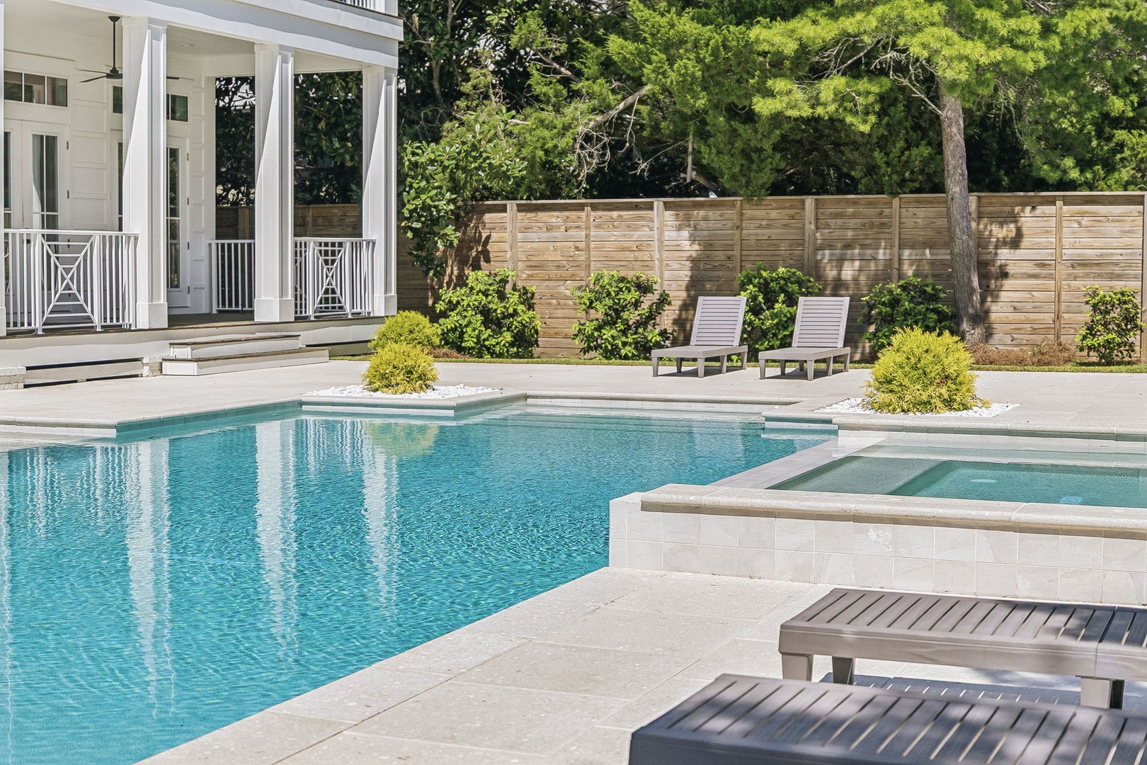 Sink into one of the poolside loungers and soak up the sun—your private oasis awaits with sparkling water, lush greenery, and plenty of space to unwind.