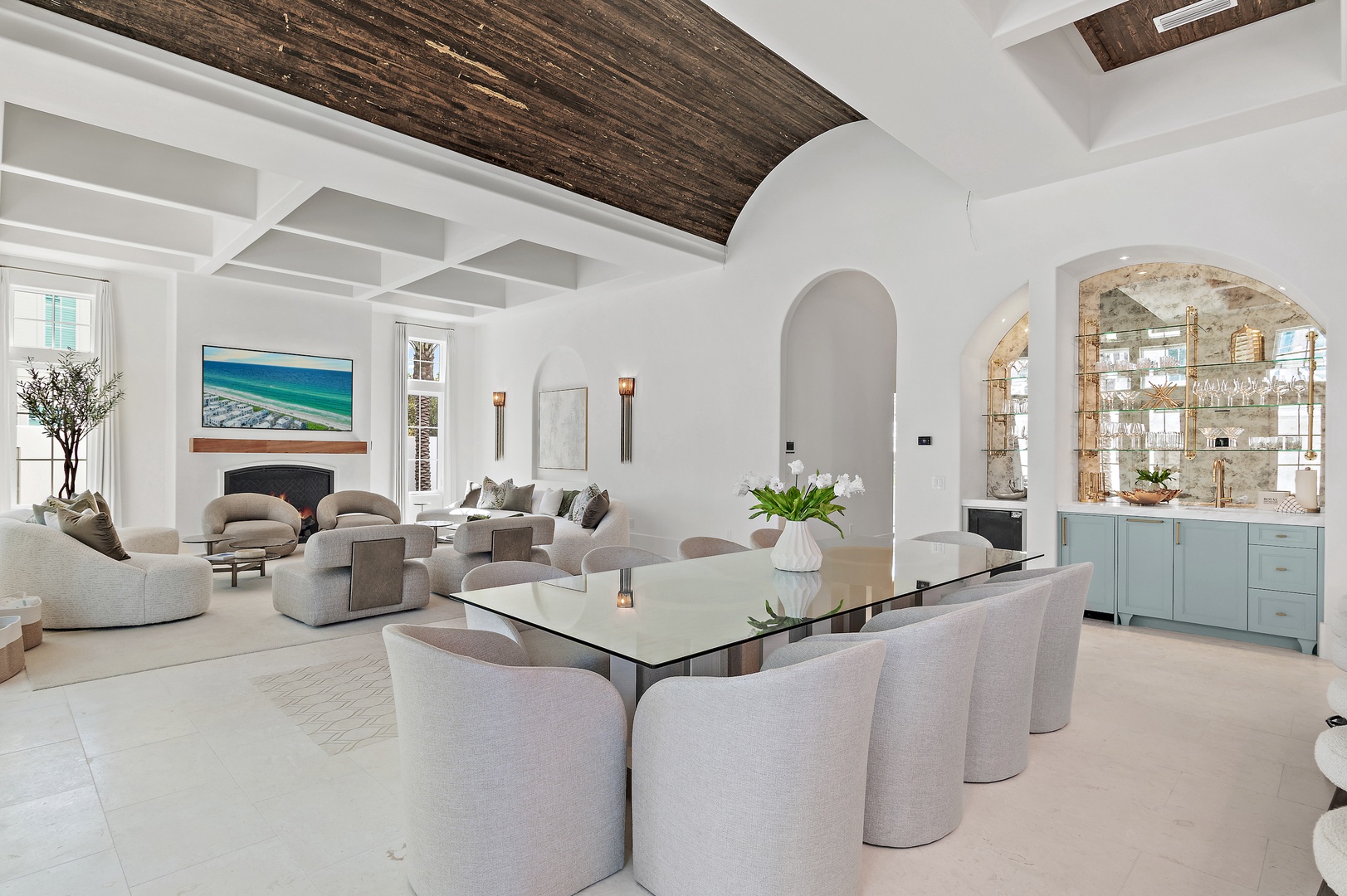 Unwind in your open-plan living and dining space, where dramatic wood-beam ceilings meet calming coastal tones and plenty of natural light.