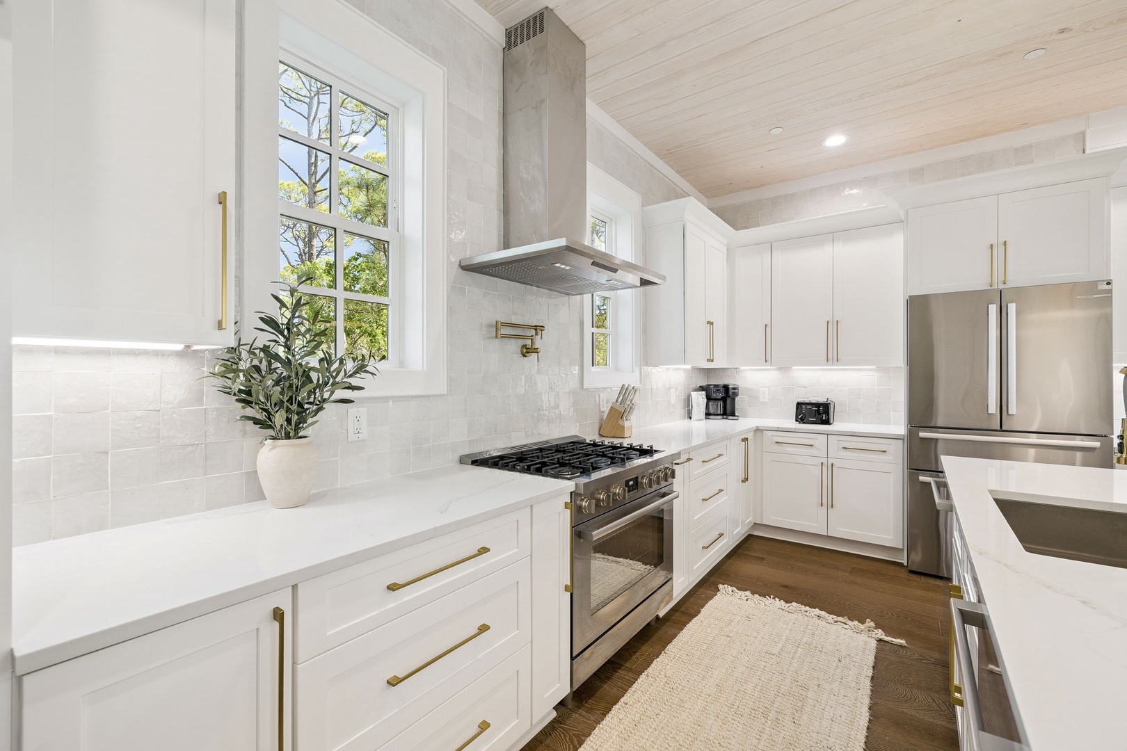 Your gourmet kitchen awaits with gleaming quartz counters, premium appliances, and abundant natural light streaming through garden views.