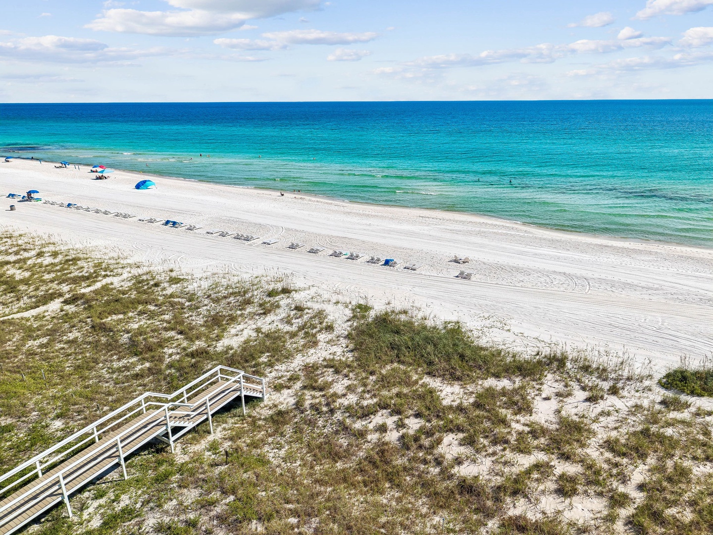 Pristine white sand beach with stunning turquoise waters awaits just steps away, offering the perfect backdrop for unforgettable coastal adventures and peaceful seaside relaxation.