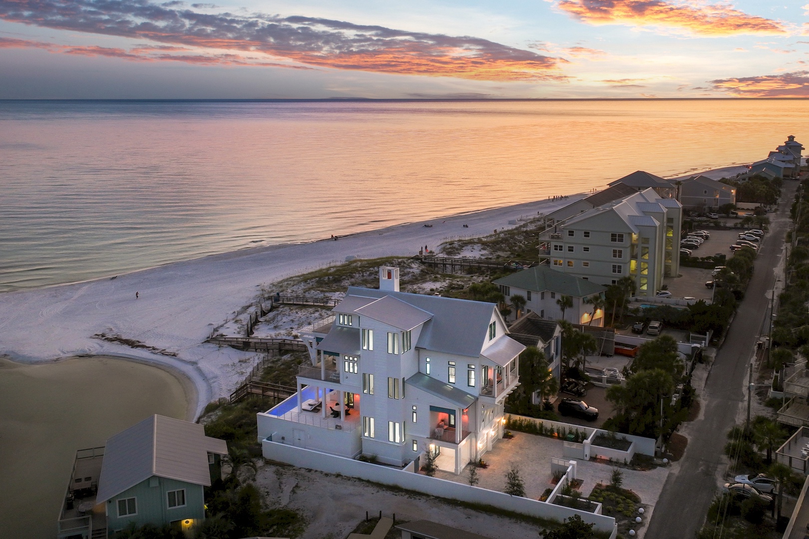 This stunning beachfront property sits along pristine white sand shores with direct access to calm Gulf waters. The contemporary multi-level home features expansive balconies overlooking miles of coastline, surrounded by peaceful residential charm.