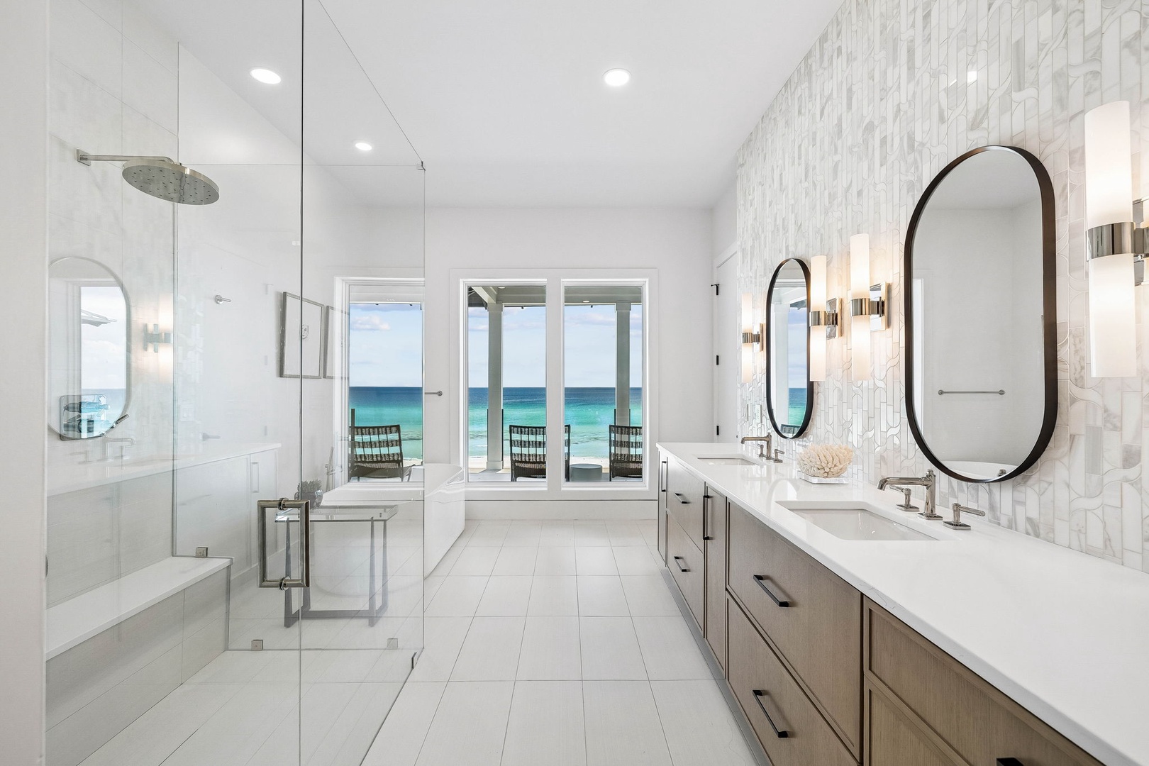 Unwind in your serene spa-like bathroom, where white marble and coastal colors blend seamlessly. Refresh with a rainfall shower, then step out to that glorious ocean view just beyond your private balcony doors.