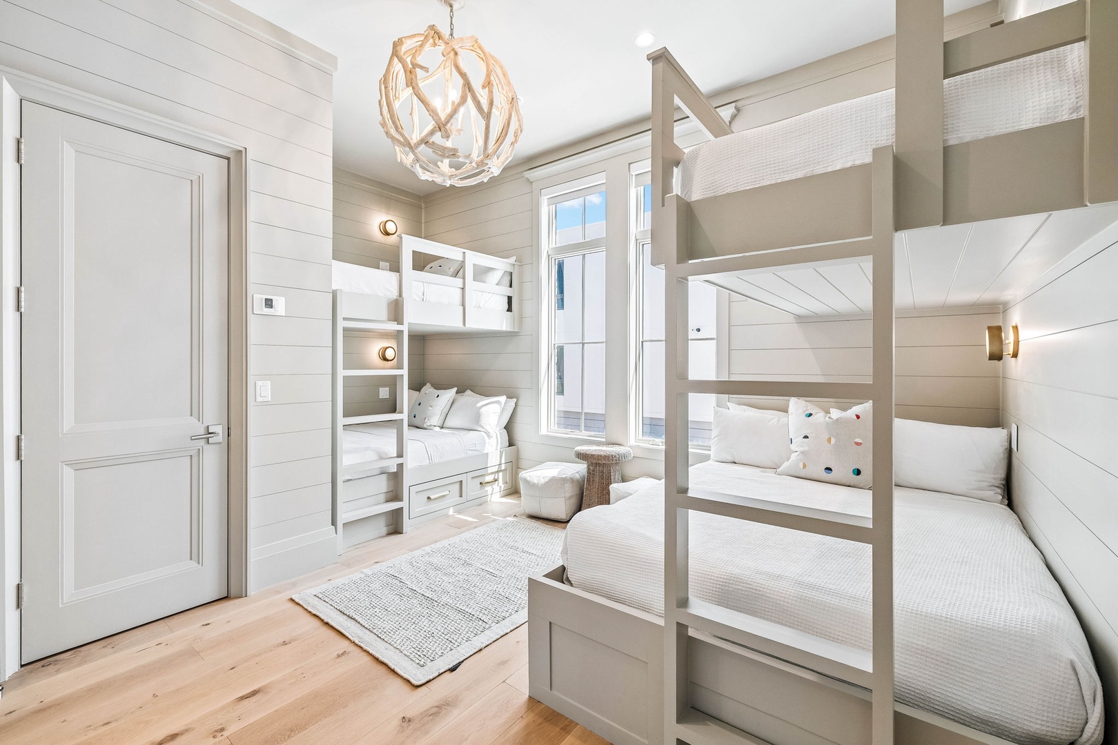 Your group can rest easy in this charming bunk room with four cozy beds and soft linens. Shiplap walls and warm lighting create a coastal retreat where laughter and stories are shared.