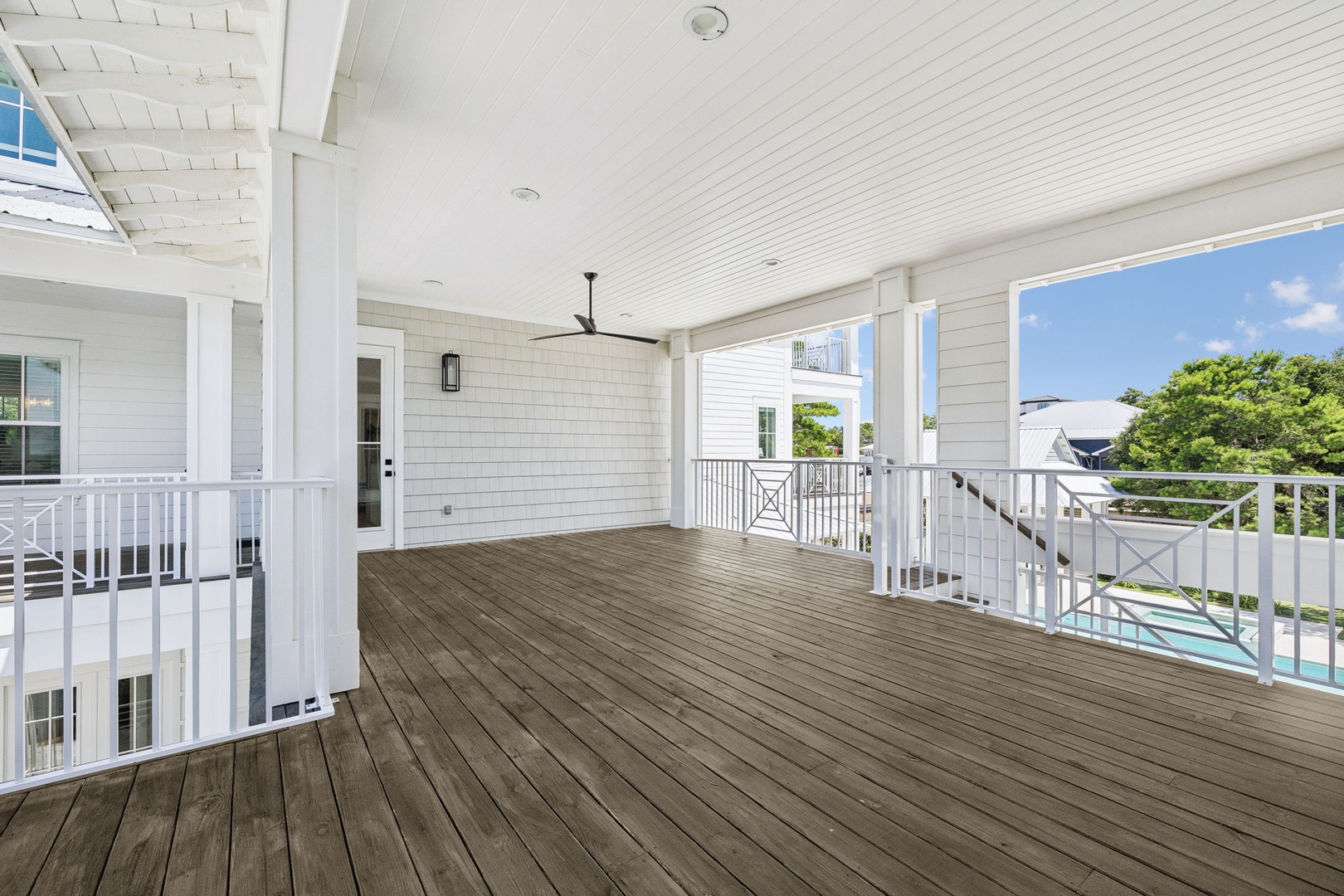 This spacious second-floor balcony offers peaceful views of lush treetops and neighboring homes—a perfect spot to enjoy your morning coffee or evening breeze in complete tranquility.