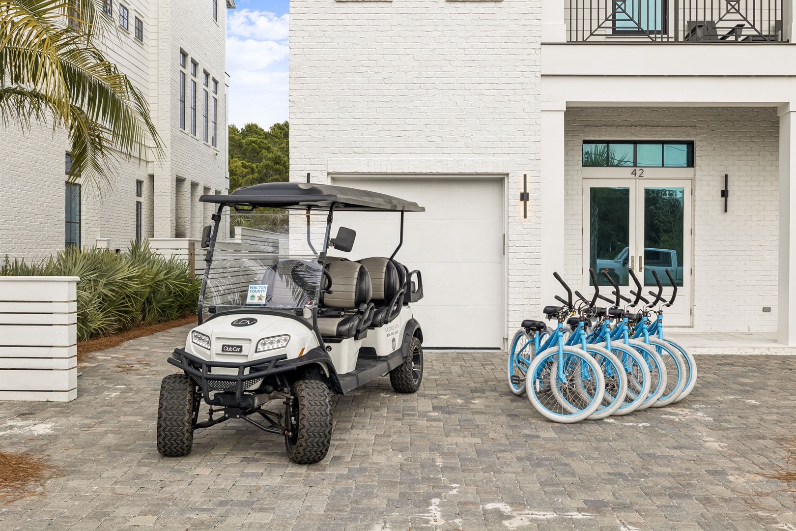 Modern beach house featuring complimentary golf cart and bicycle fleet for exploring the coastal area.