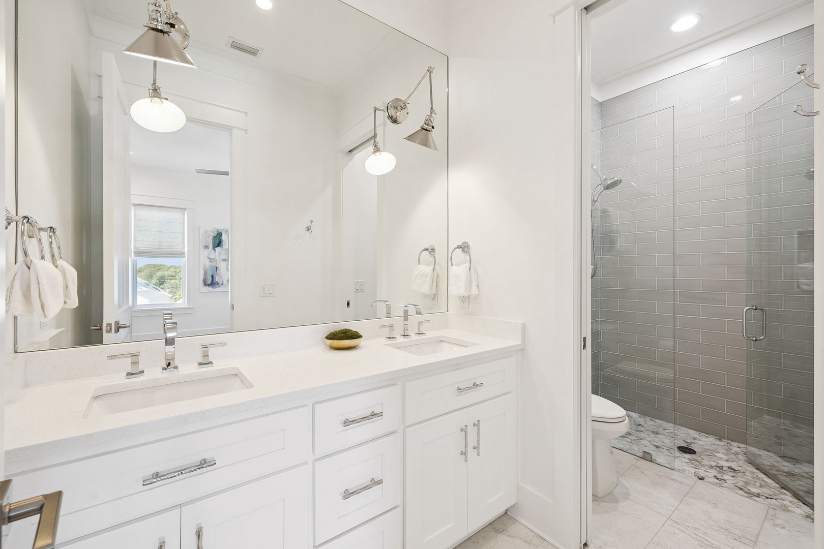 Luxurious marble bathroom with dual vanities, rainfall shower, and elegant lighting creates your perfect morning routine.