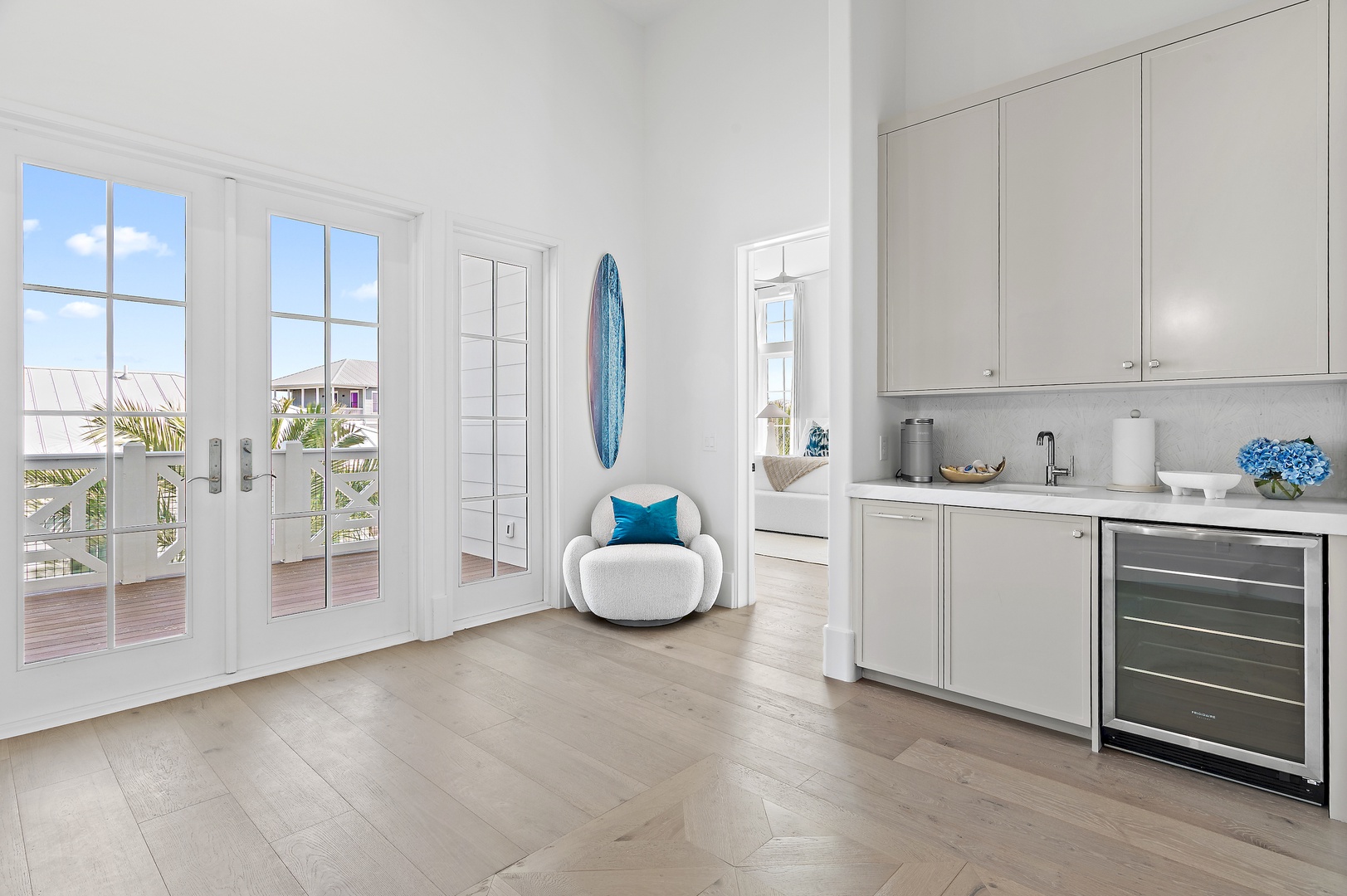 Step into your bright, coastal-inspired haven where beachy vibes meet modern convenience. Sleek kitchenette and doors to your private terrace await your relaxation.