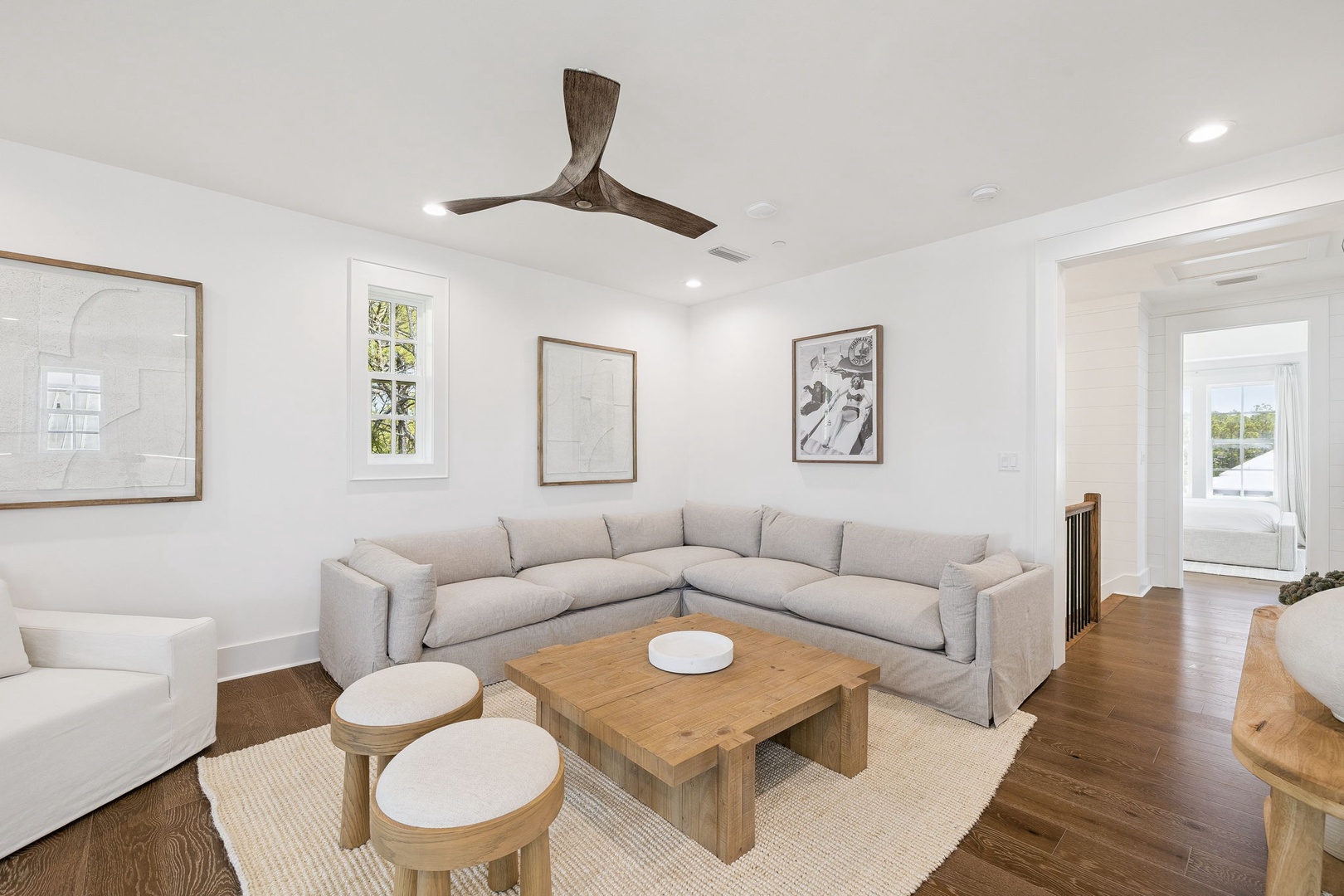 Sink into this spacious sectional sofa where you'll love gathering with family, enjoying the natural light and contemporary artwork.