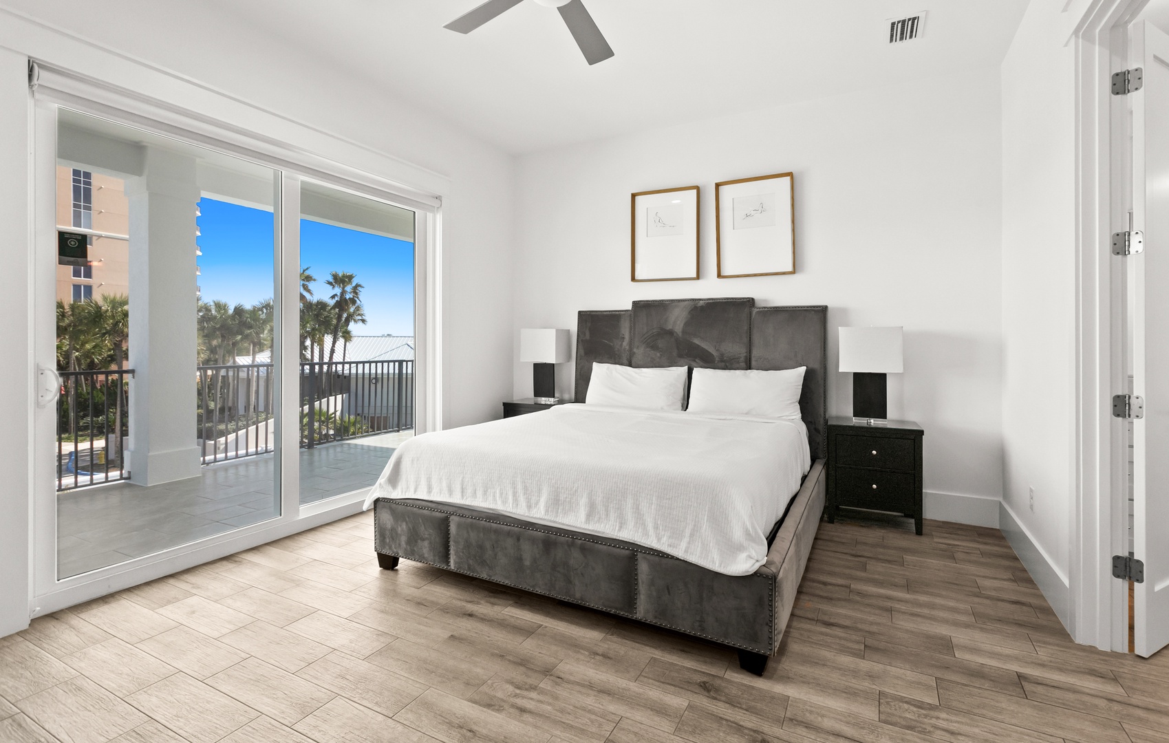 Wake to palm trees swaying beyond your balcony doors and crisp white linens inviting you to drift off beneath the ceiling fan. Your modern bedroom opens straight onto a private terrace overlooking tropical surroundings.