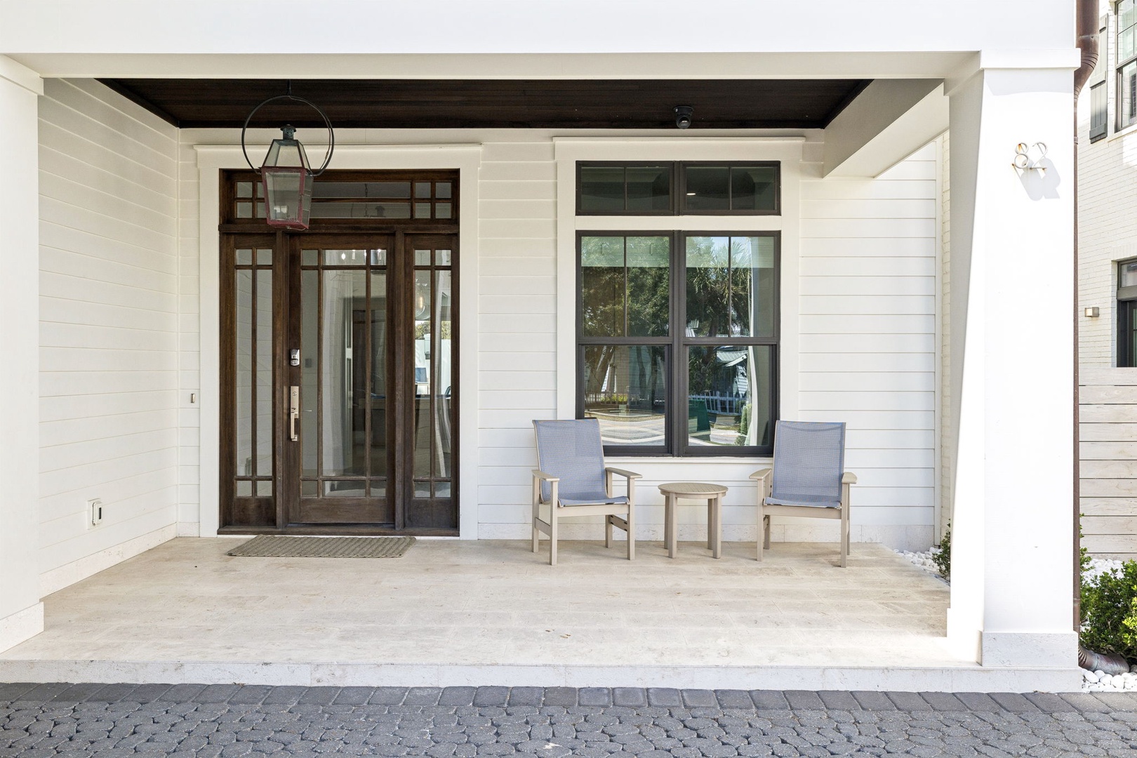 Welcome to your elegant covered porch with comfortable seating where you can relax and unwind in the fresh air.