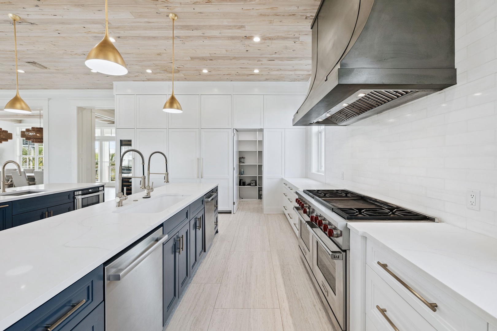 Your culinary dreams come alive in this chef's paradise with premium appliances, marble countertops, and golden pendant lighting.