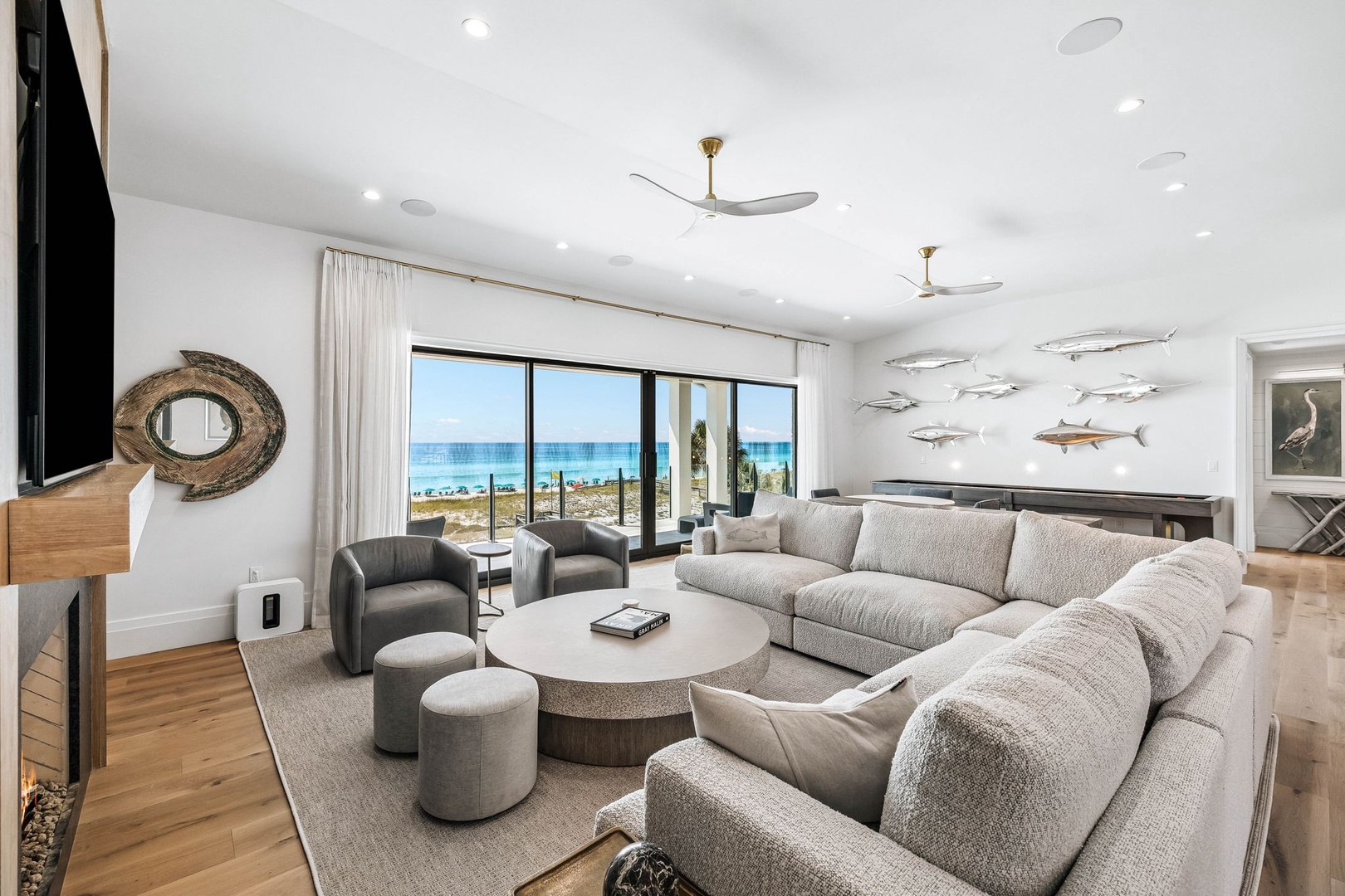 Settle into the plush sofas and let your eyes drift to the sparkling turquoise ocean just beyond your window—a bright, breezy retreat designed for effortless relaxation.