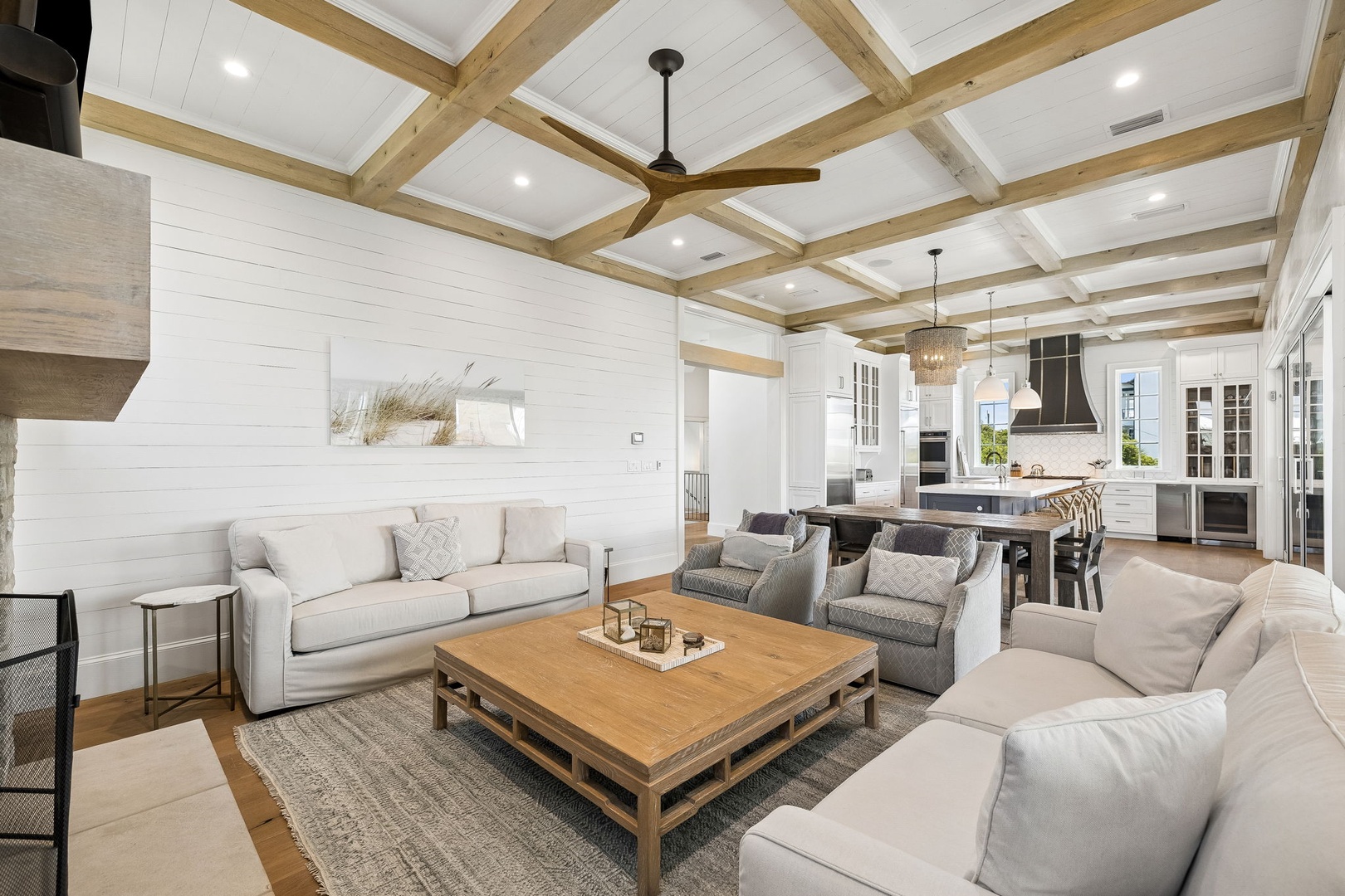 Unwind in your elegant open-concept living space, where soaring wood-beam ceilings and coastal-chic décor invite relaxation after a day exploring nearby attractions.