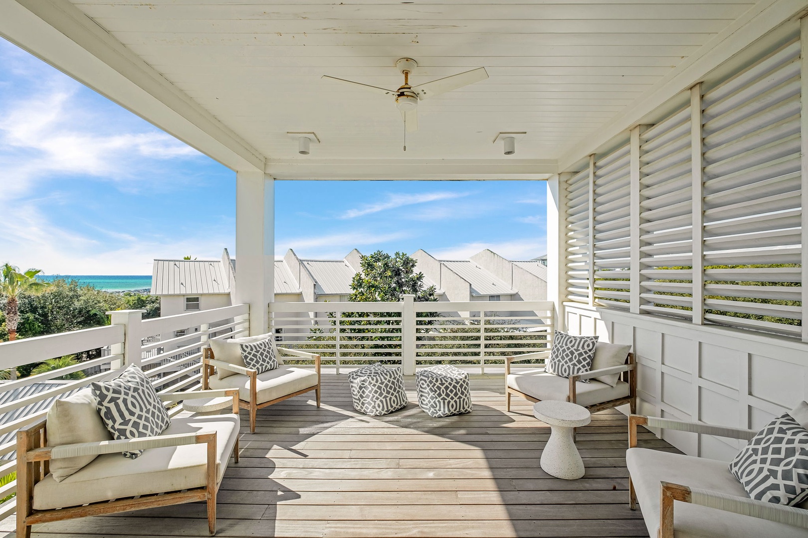 Unwind on your private covered terrace with coastal views, stylish lounge seating, and cooling sea breezes.