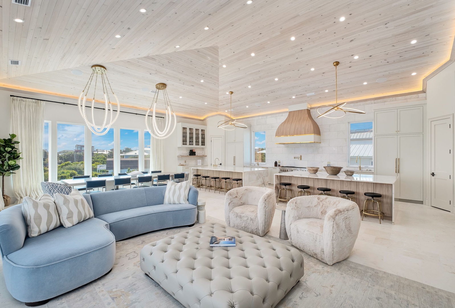Unwind in your luxurious open-concept living space with soaring shiplap ceilings, designer lighting, and a gourmet kitchen perfect for entertaining. Plush seating invites you to relax while scenic windows frame your beautiful surroundings.