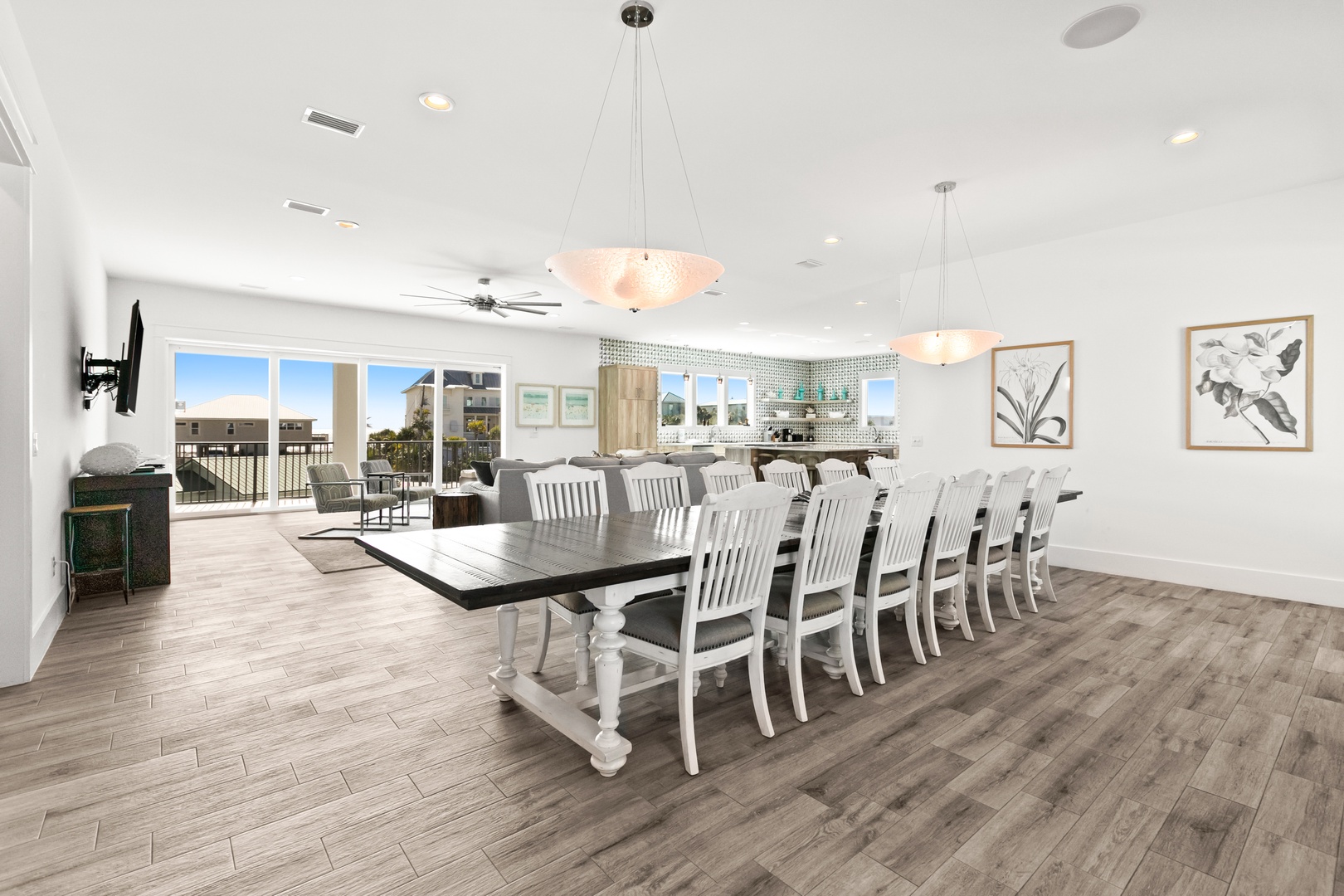 Gather everyone around this grand dining table that seats the whole crew comfortably. Natural light pours in through sliding doors that open to your outdoor balcony, where coastal breezes and palm trees await.