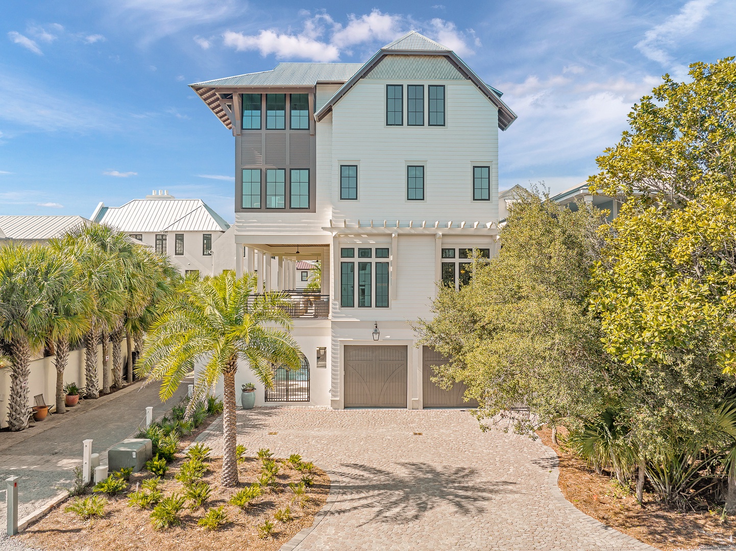 Stunning coastal architecture with tropical landscaping and convenient ground-level parking in this beautifully designed three-story home.