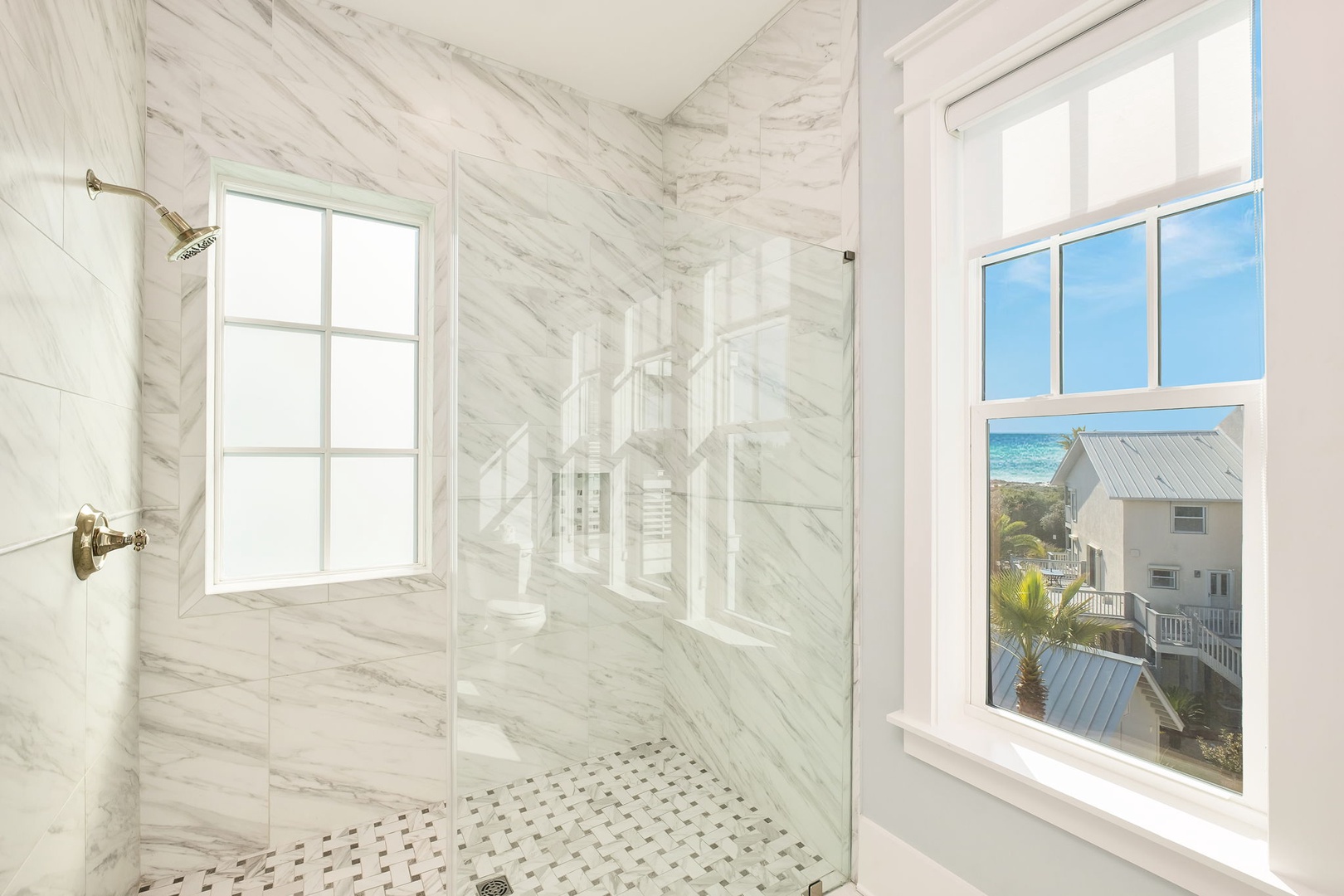 Luxurious marble shower with stunning ocean views creates your perfect morning retreat.
