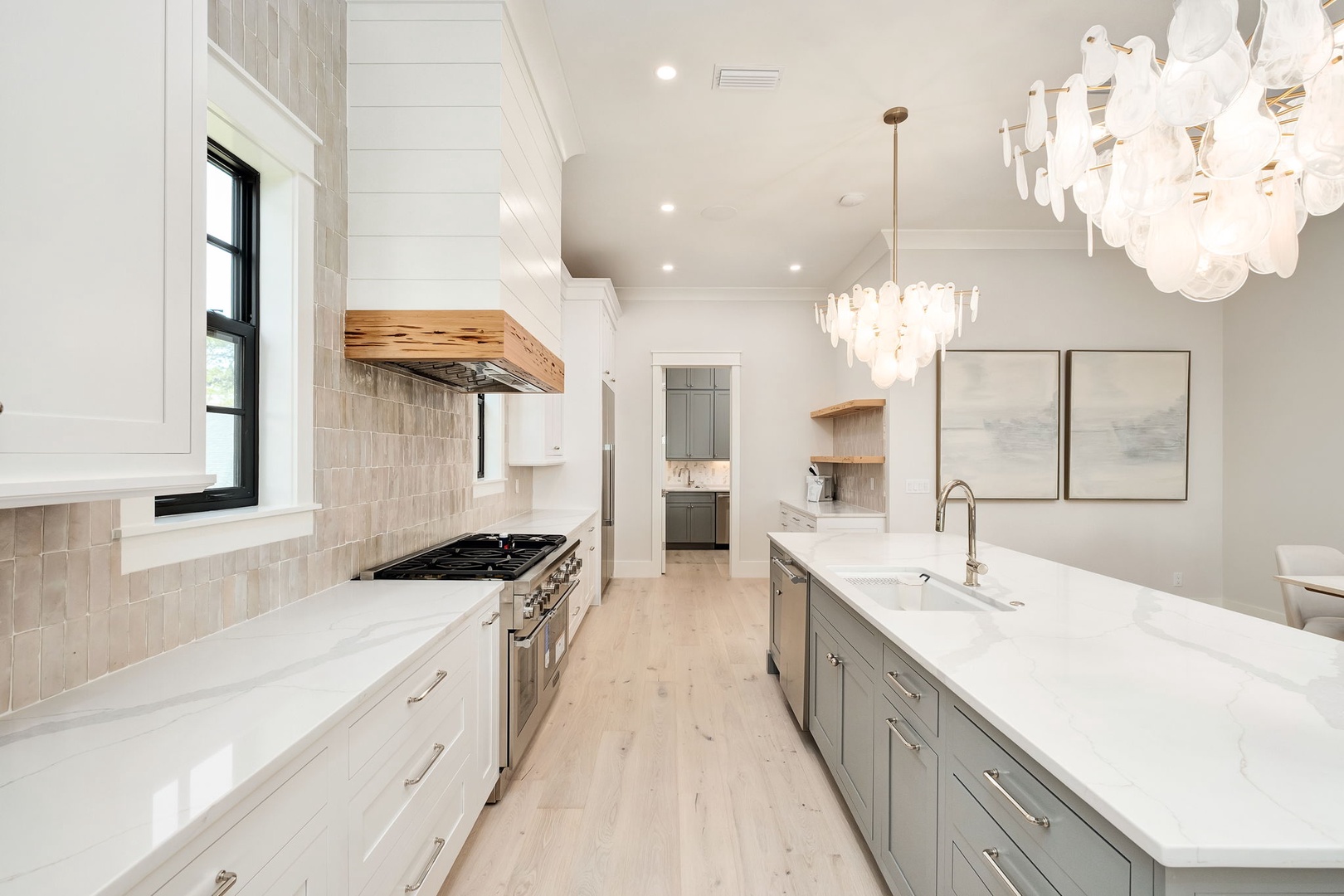 Your gourmet kitchen awaits with marble counters, professional appliances, and elegant chandeliers for memorable meal preparations.