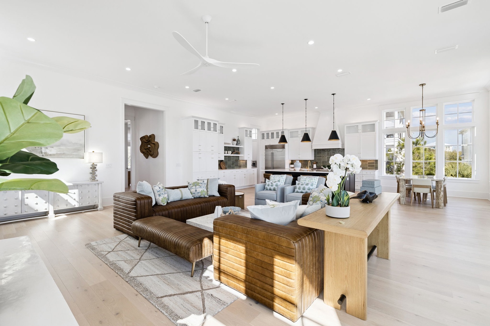 Relax in this stunning open-concept living space where natural light floods through expansive windows, highlighting elegant furnishings and modern amenities.